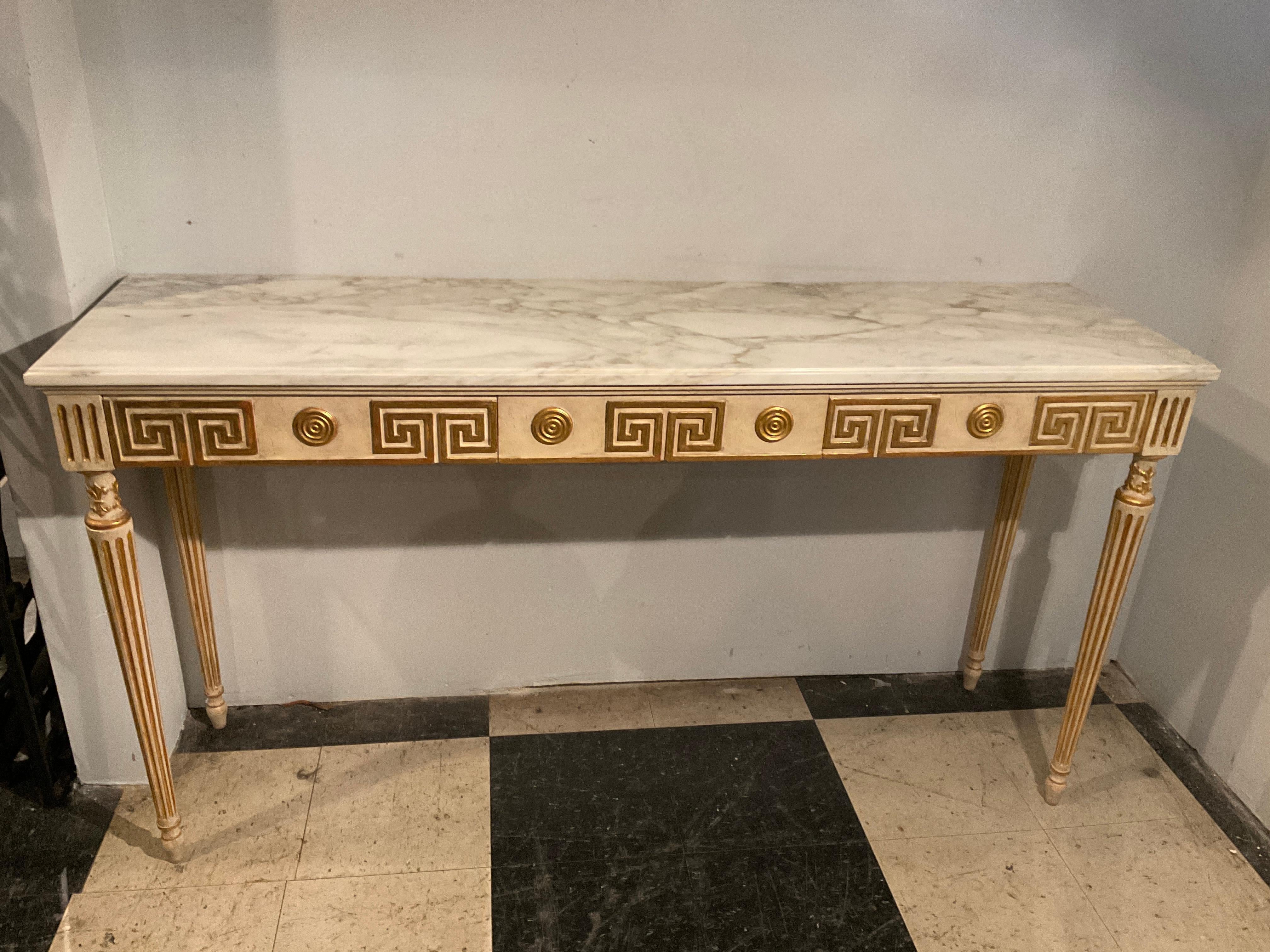 1950s Italian gilt wood Greek key console. Three drawers . Beautiful marble top with light brown veins. Clearance Measurement underneath is 26.75