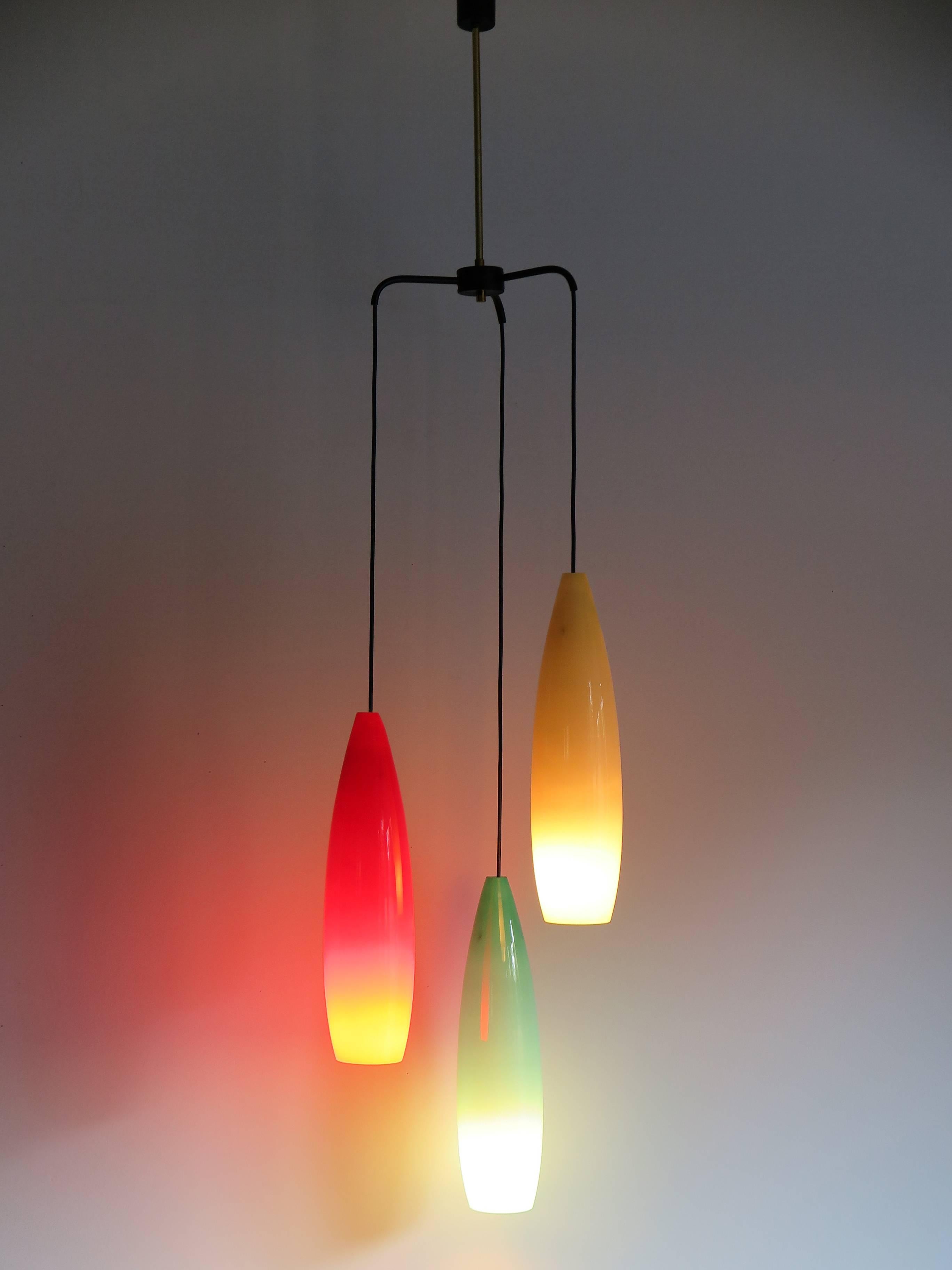 1950s Italian pendant lamp with painted metal structure with brass detail and colored glass diffusers, the height of each individual glass diffuser is 46 cm.