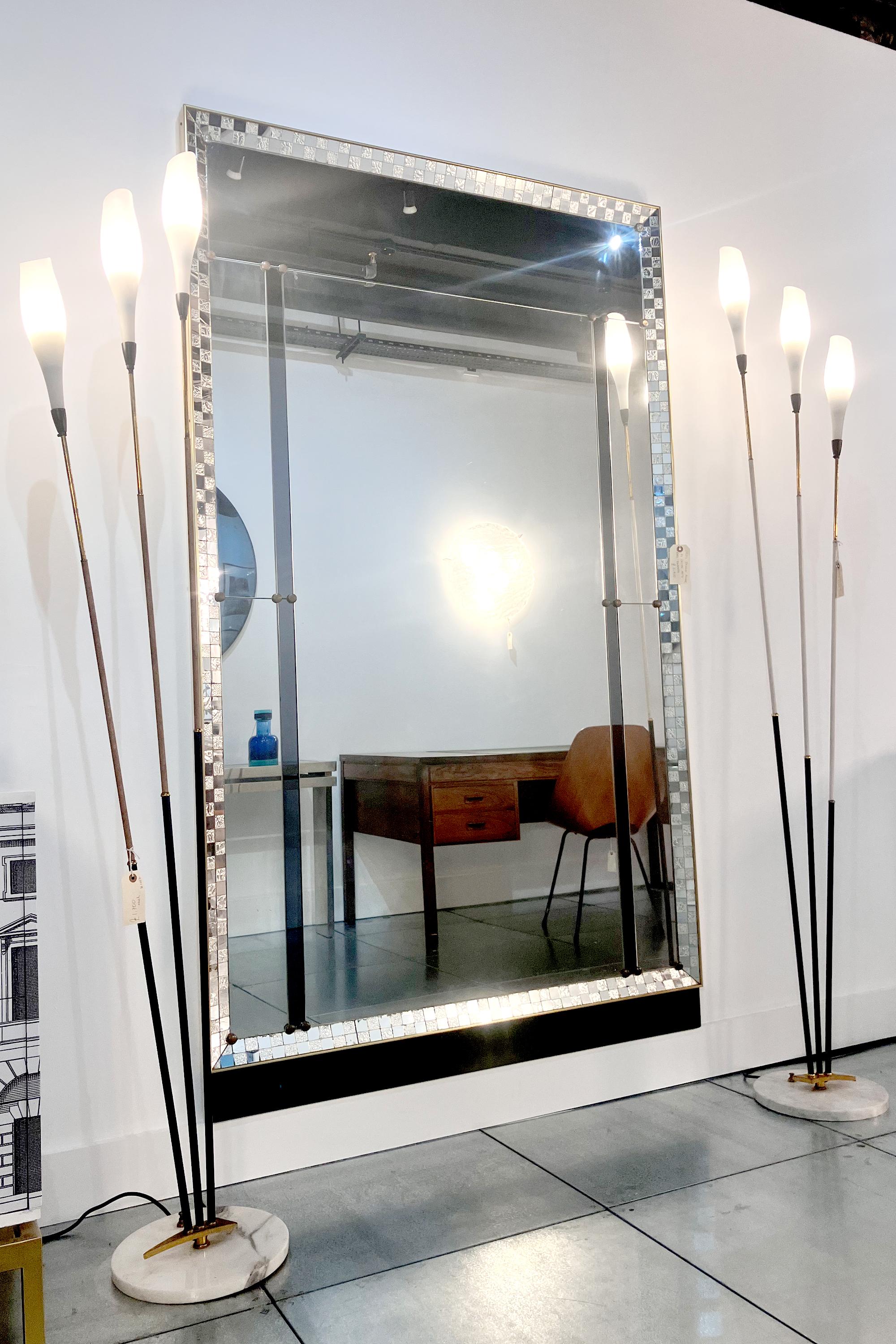 An impressive, large and beautiful Italian 1950's wall mirror, with glass mosaic detailing and brass frame by Cristal Arte. 
Its Hollywood Regency style and patinated glass finish give it an amazingly sophisticated antique look. Its brass frame