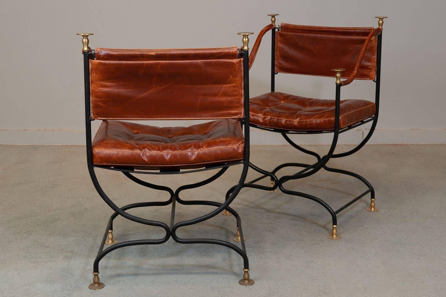 1950s Italian leather, brass and iron campaign chairs. New leather upholstery. Measures: Arm height 26.75