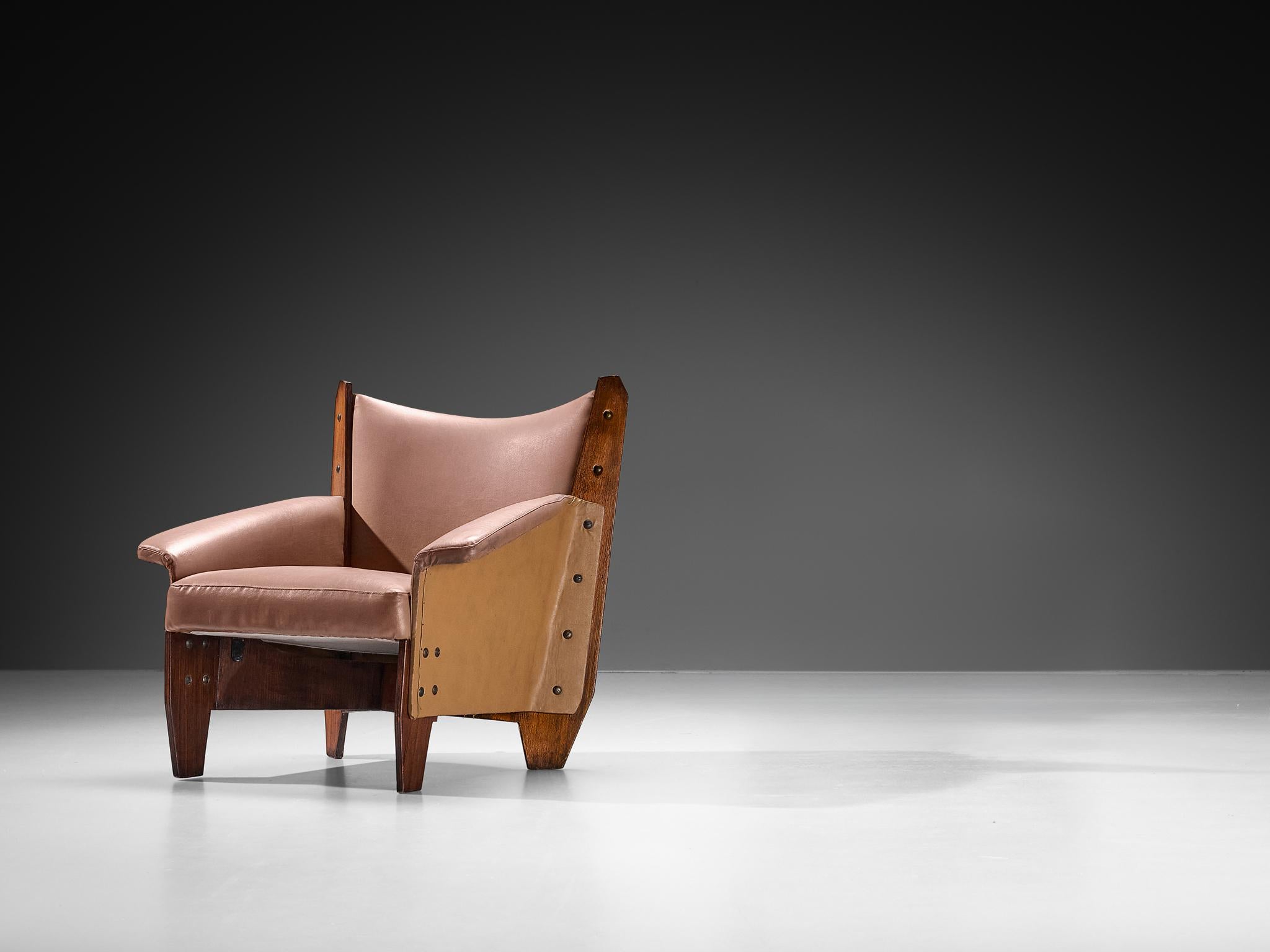 Questa poltrona lounge, realizzata in compensato di mogano, ecopelle e metallo in Italia negli anni '50, incarna una forma squisita resa possibile dalla qualità intrinseca del compensato, che si traduce in linee nitide ed eleganti e in una geometria