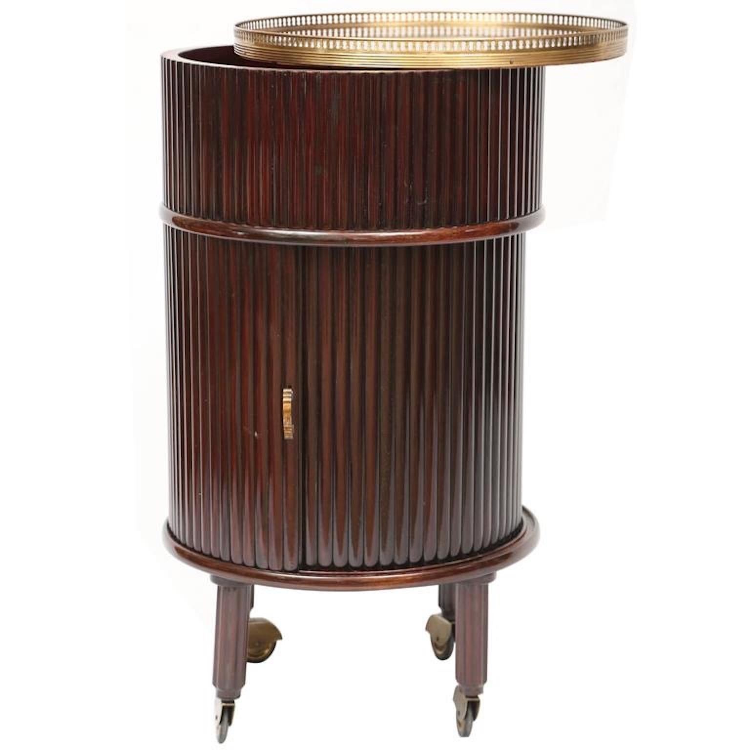 Osvaldo Borsani style 1950s Italian columnar form rolling cocktail cabinet in reeded grizzinato vertical strips of mahogany and matching tambour door which opens to reveal a circular compartment lined with red velvet and a Lazy Susan with slots to
