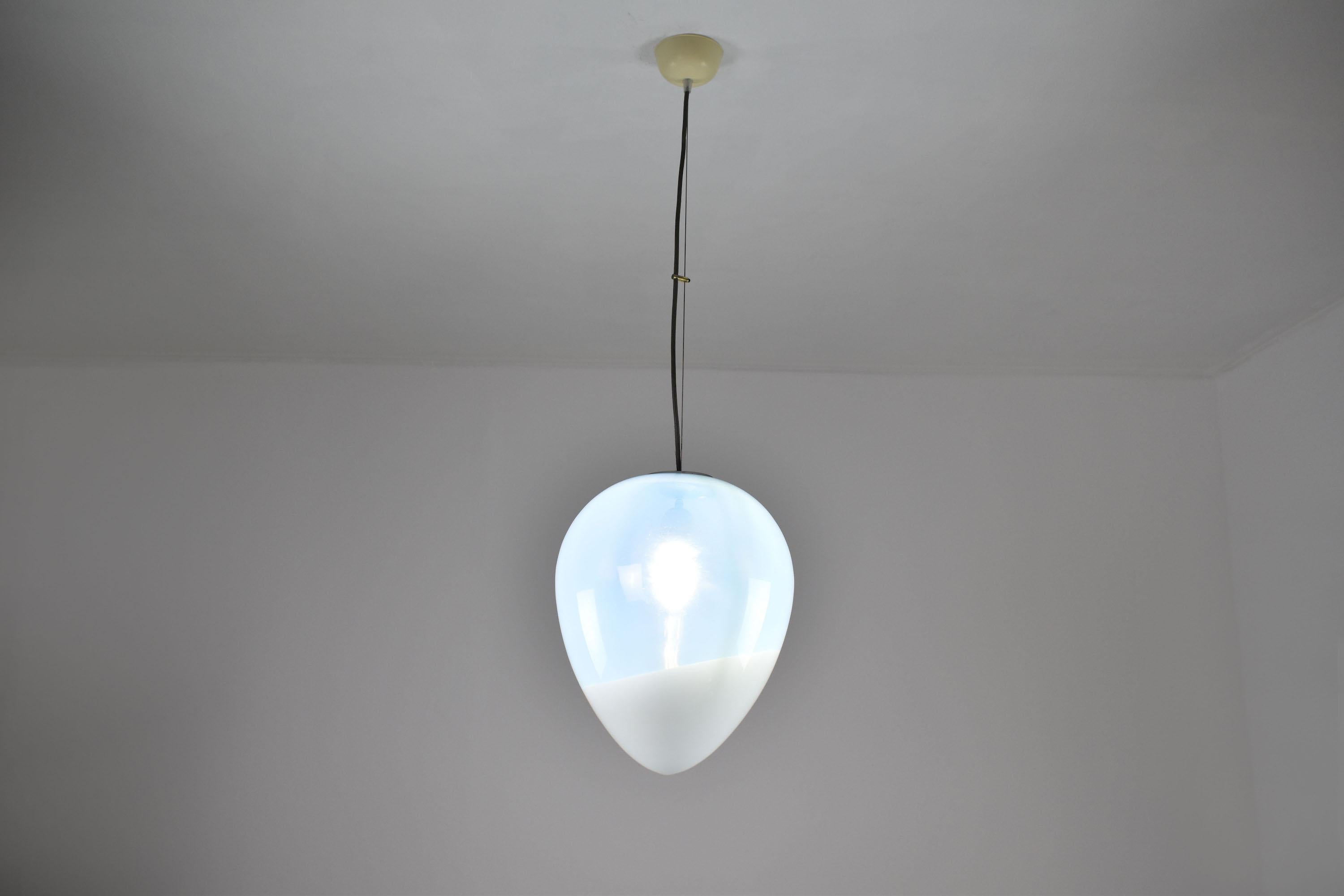 An elegant 1950s vintage single glass tear-shaped pendant design with two types of clear and milk glass creating a beautiful diffused light. 
Italy. Circa 1950's 

---

We are an exhibition space and an online destination established by the