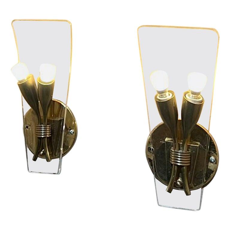 1950s Italian brass wall sconces with plexiglass sheet from Italy
Sculptural curve. Set of two sconces.
No label. In the style of Gio Ponti.
11 tall x 4.75 width x 3 depth
Patina present.
Original vintage preowned condition. 
Upgraded and in great