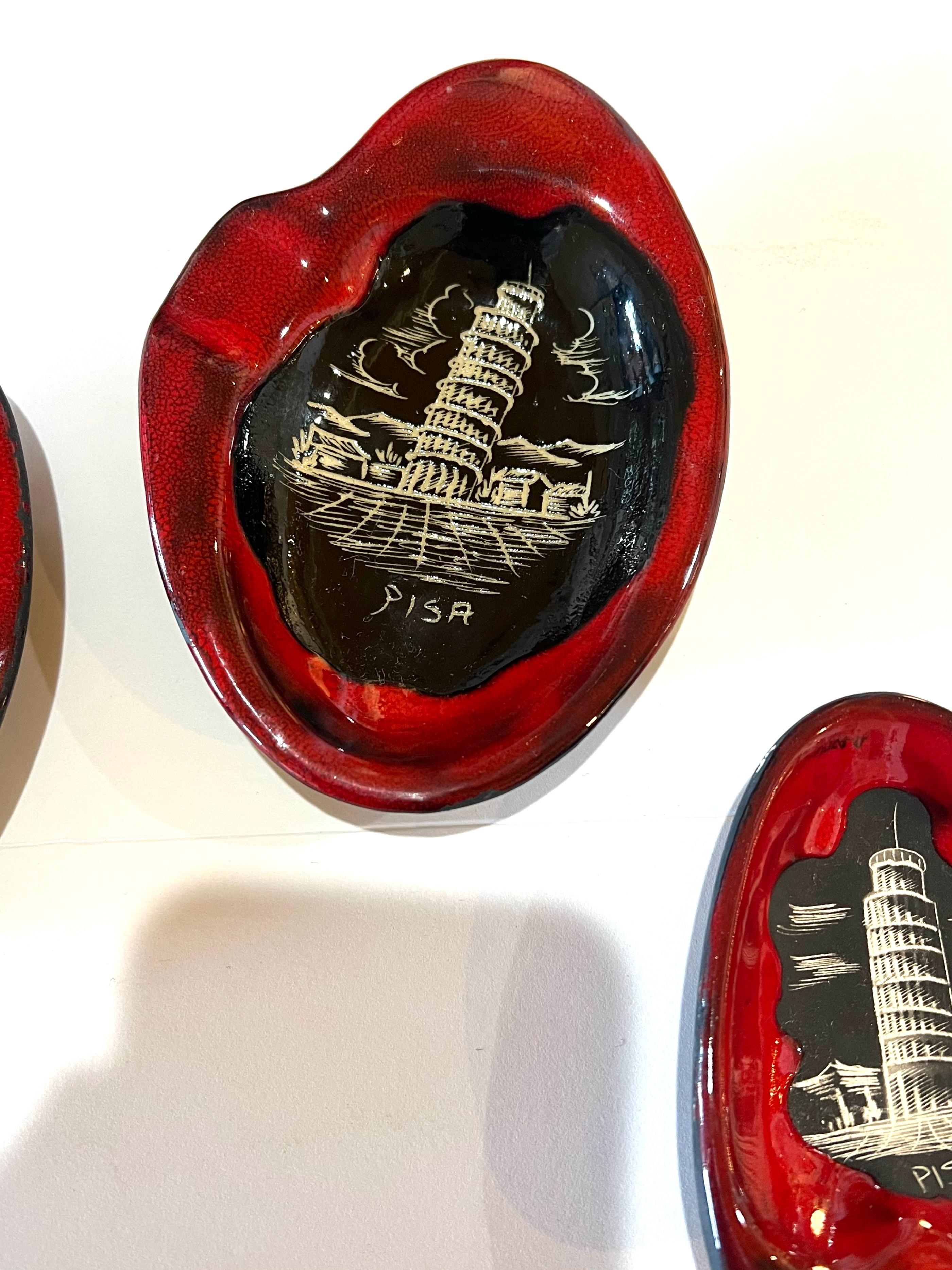 An incredible set of 3 freeform ashtrays souvenirs from the tower of Pisa .Italy, these set was never used condition its like new no chips or cracks , hand painted and beautiful red glaze , made by Titano republica de San Marino, a very hard to find