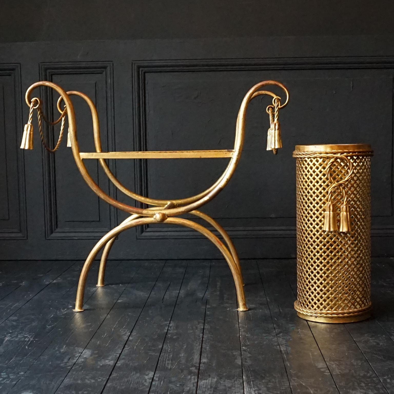Vintage MCM Hollywood Regency gilt metal or tole rope and tassel stool or bench and umbrella stand.
This fantastic set would look great in any hallway. 
I just love the turned lifelike rope and tassel design. 
The condition of both is very good and