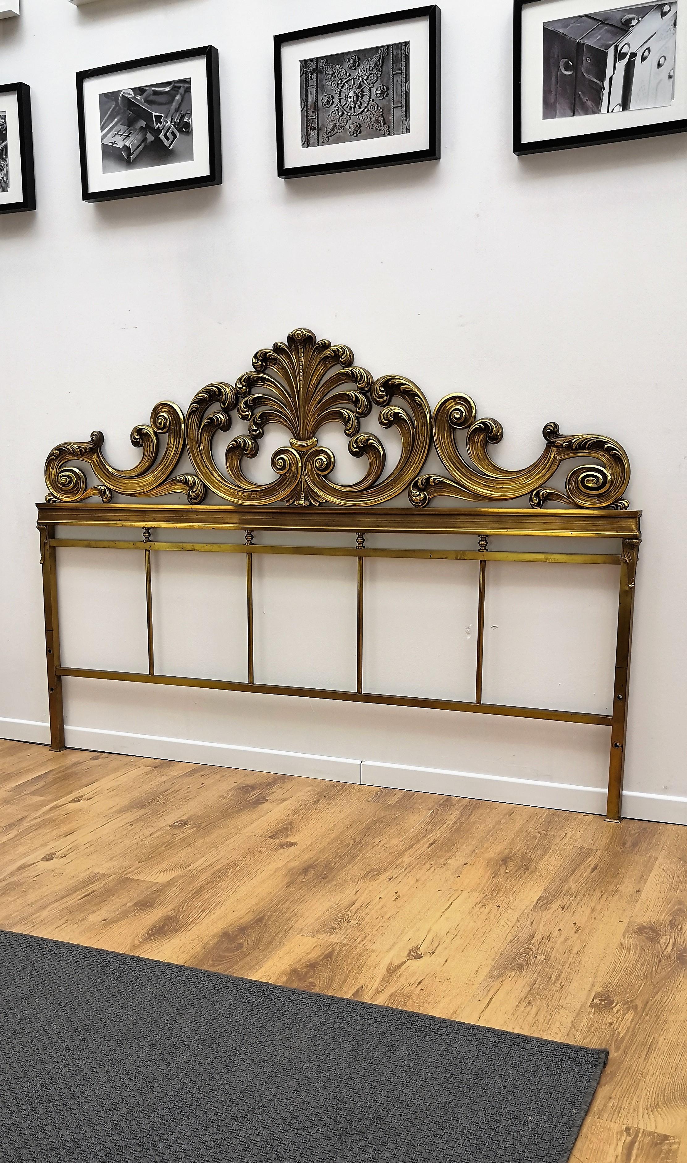 Beautiful and stylish Italian Baroque neoclassical shiny brass bed headboard frame dated around the 1950s. A great piece that perfectly adds to every home decor the typical glitz, glamour, and gold of Hollywood Regency style, with a nod to Art Deco