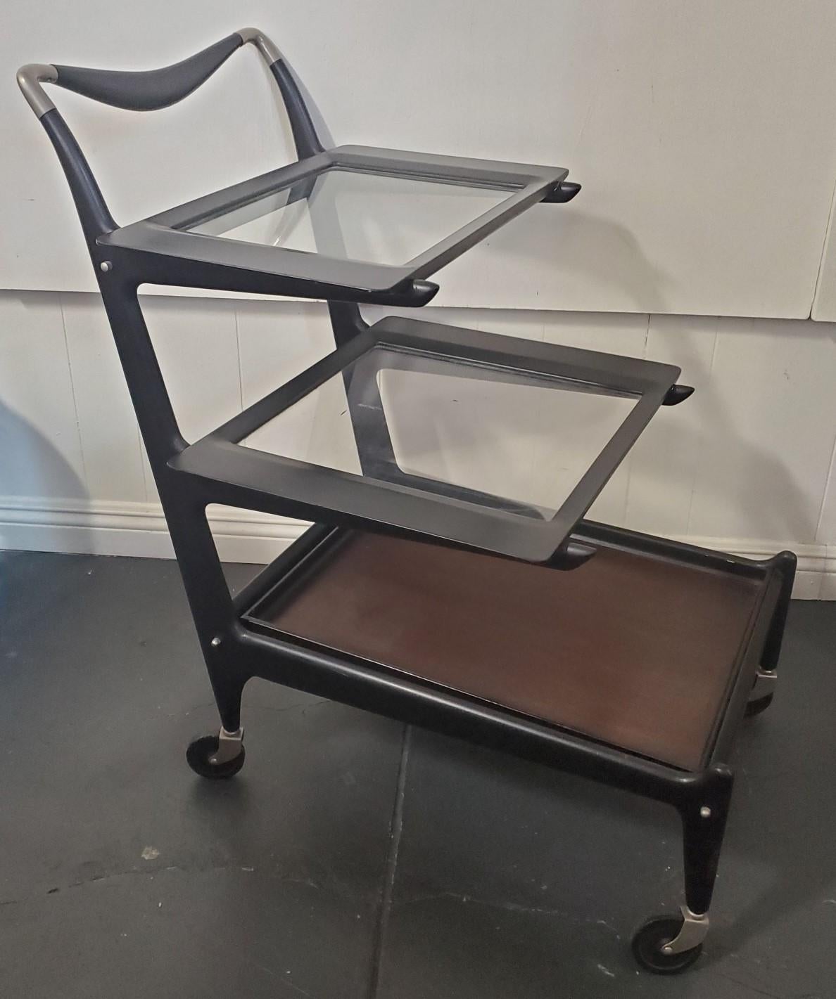Italian modern tea trolley bar cart by Cesare Lacca 1950s with removable tiers. Each tier fits exactly in the position it is removed from The top 2 tiers have a plexy-glass like transparent material and the bottom tier is made from wood with a dark