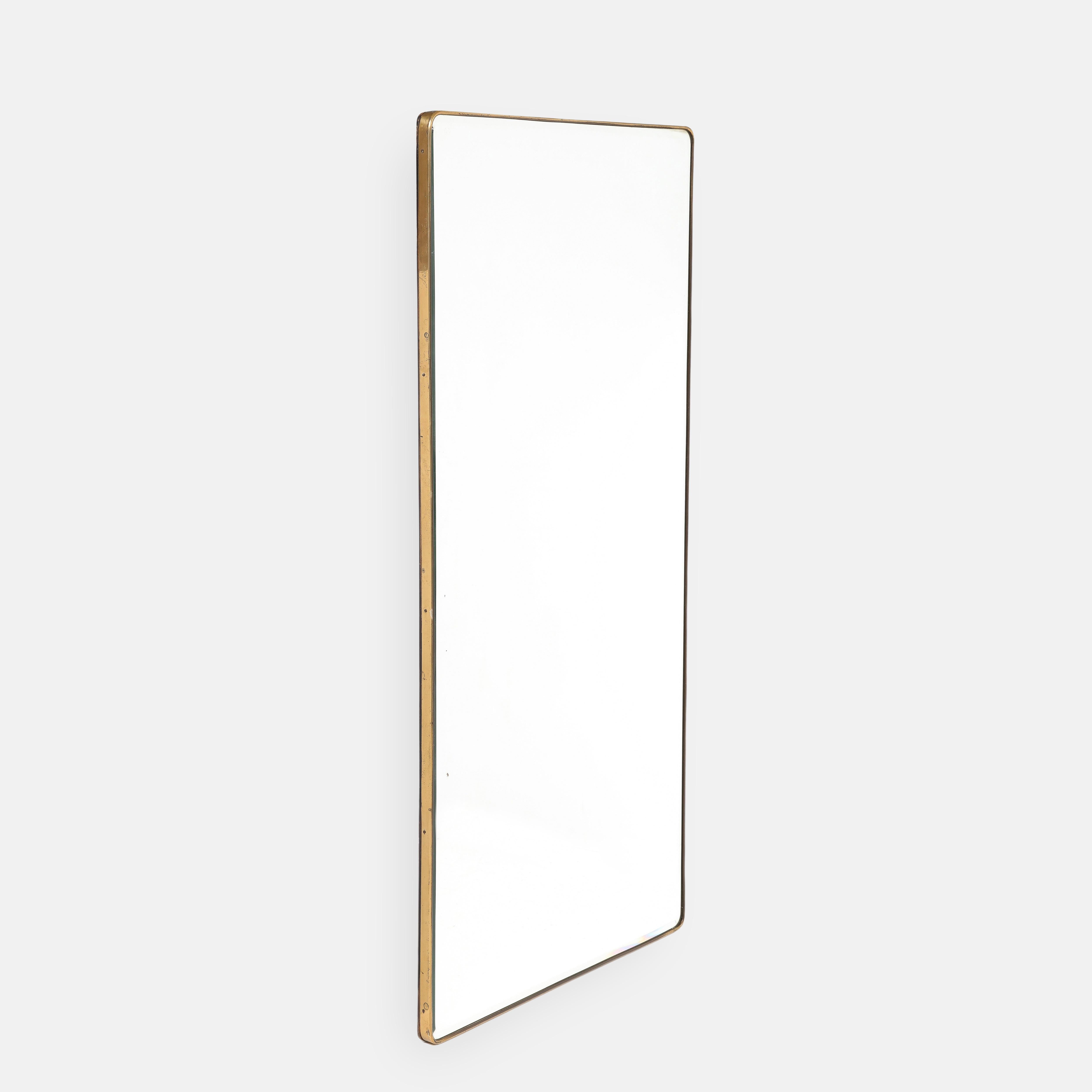 1950s Italian modernist grand scale brass wall mirror with gently rounded corners and bevelled mirrored glass. This rectangular mirror is versatile and can be hung either vertically or horizontally. This large period mirror is well constructed with