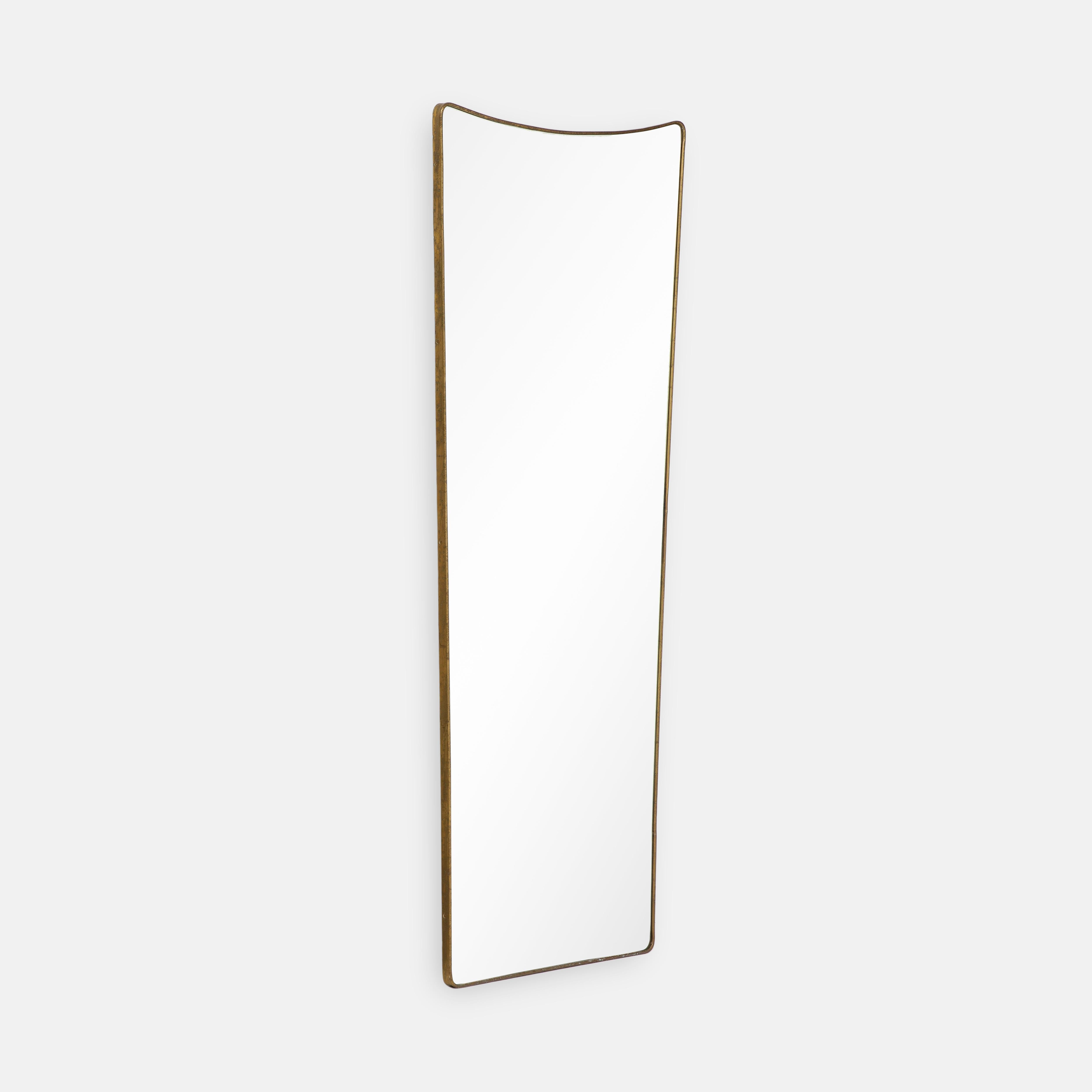 1950s Italian modernist grand scale wall mirror consisting of shaped brass frame with gently arched and rounded top which slightly tapers towards the bottom This chic and rare mirror is large and striking in size and can also be used as a standing
