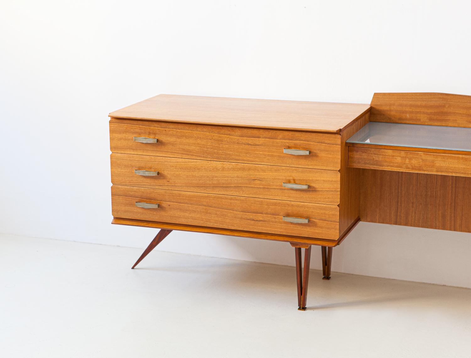 Elegant and modern sideboard manufactured in Italy during the 1950s
High quality Italian manufacture, sophisticated design

This dressing table has 4 drawers on the left, a small shelf with drawer in the center, finished with back-lacquered glass