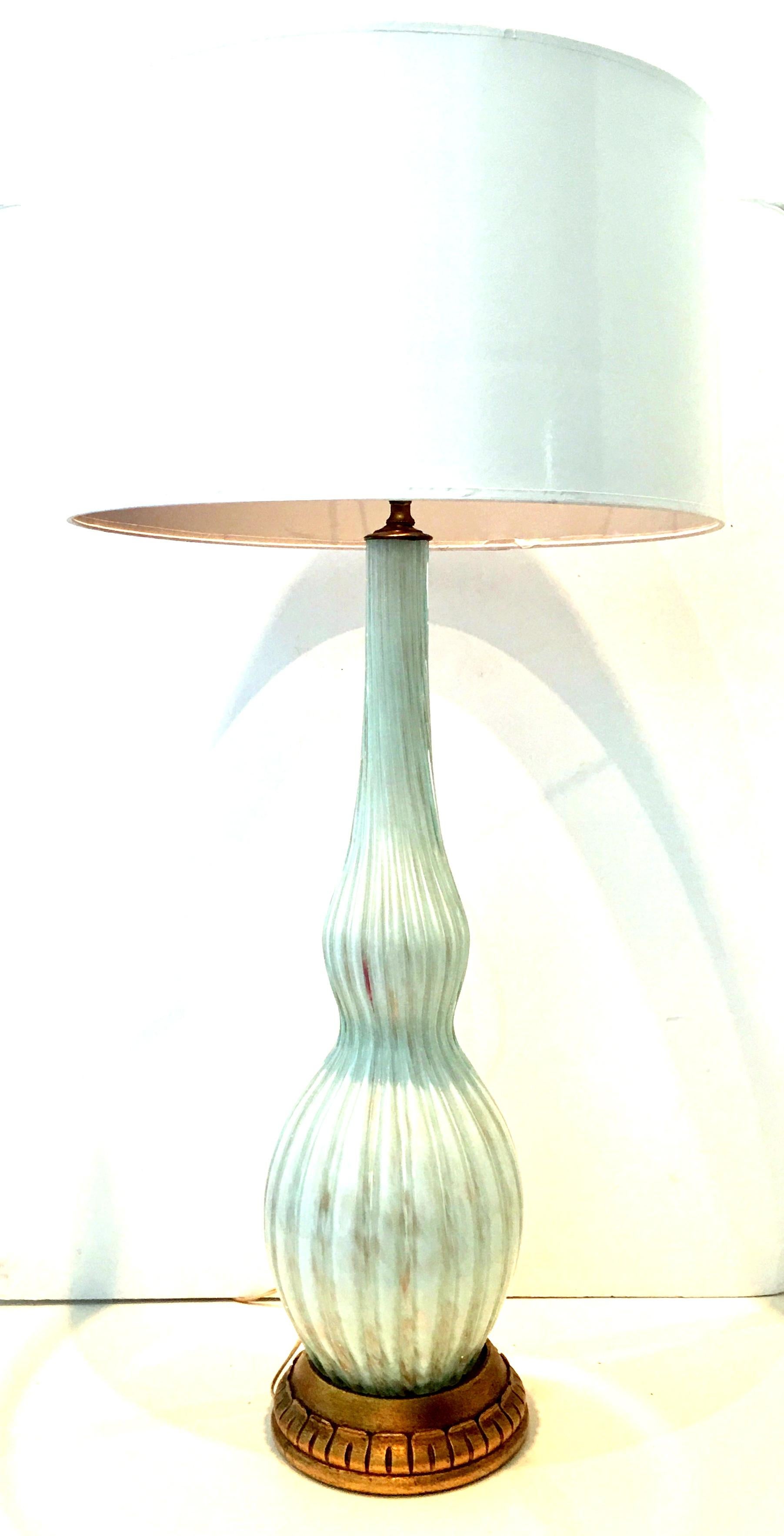 1950s Italian Marbro style Murano glass aquamarine lamp with metallic gold/copper inclusion and gilt wood base. Features original brass fittings. Includes brass harp and round brass finial. Height to socket, 31