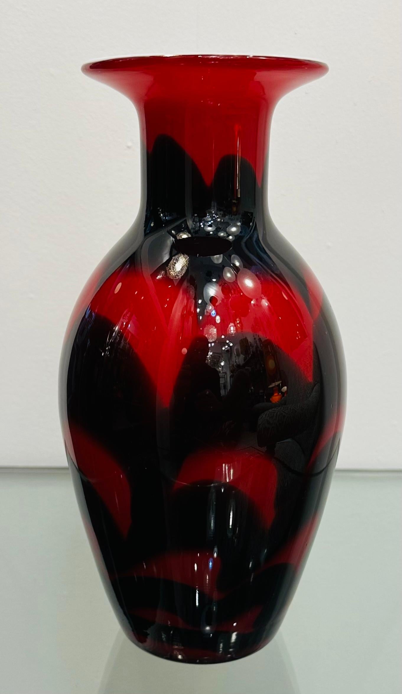 1950s Italian Murano art glass vase attributed to Carlo Moretti.  A red glass vase overlaid with a black abstract pattern with a white encased interior.  Typical style of Moretti.  In very good condition with no chips, scratches or