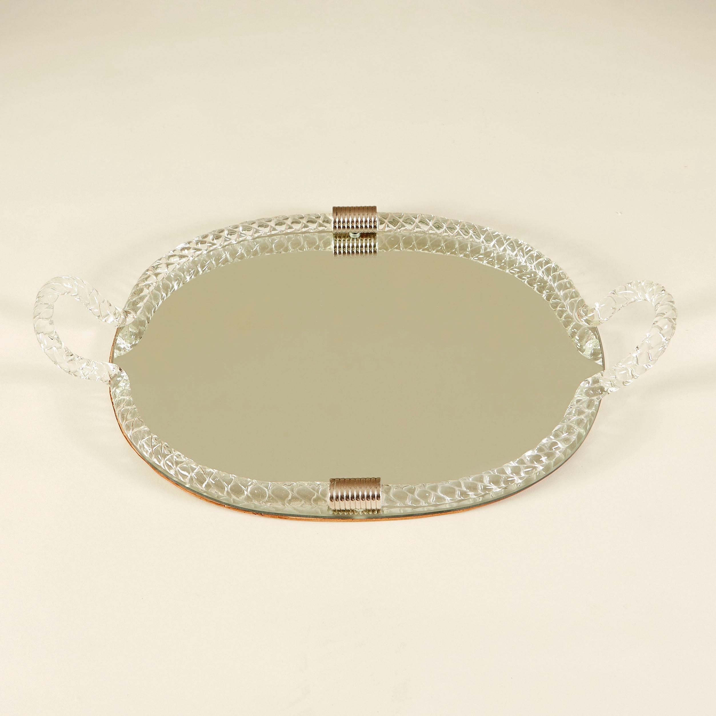 Unusual large oval tray with Murano glass rope frame and handles. Decorated with two chrome ribbed metal clasps. Mirrored top sits on rosewood base. Perfect for the dressing-table or chic bar display.
 