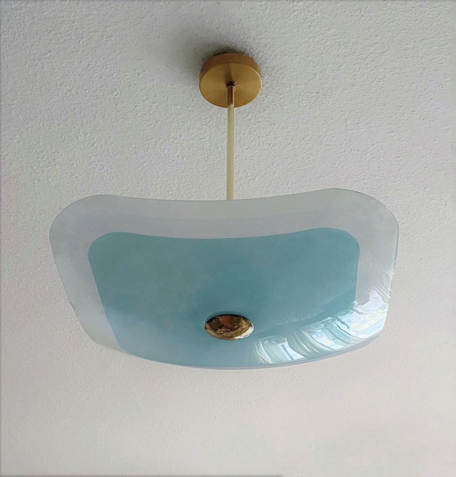 A Fontana Arte style opalescent glass two-light chandelier or flush mount, Italy, 1950s. Large curved quare turquoise and white opalescent glass shade with brass mounts. This chandelier can also be used as flush mount on the ceiling. The glass is in