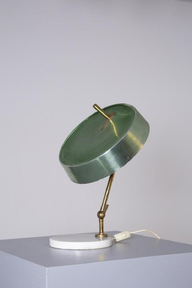 Midcentury Italian Oscar Torlasco table lamp with white marble base and adjustable brass structure, 1950s. Lamp holder cap/shade in bright green painted aluminum. Single light socket. 

Italian lighting designer Oscar Torlasco (born in Rome,