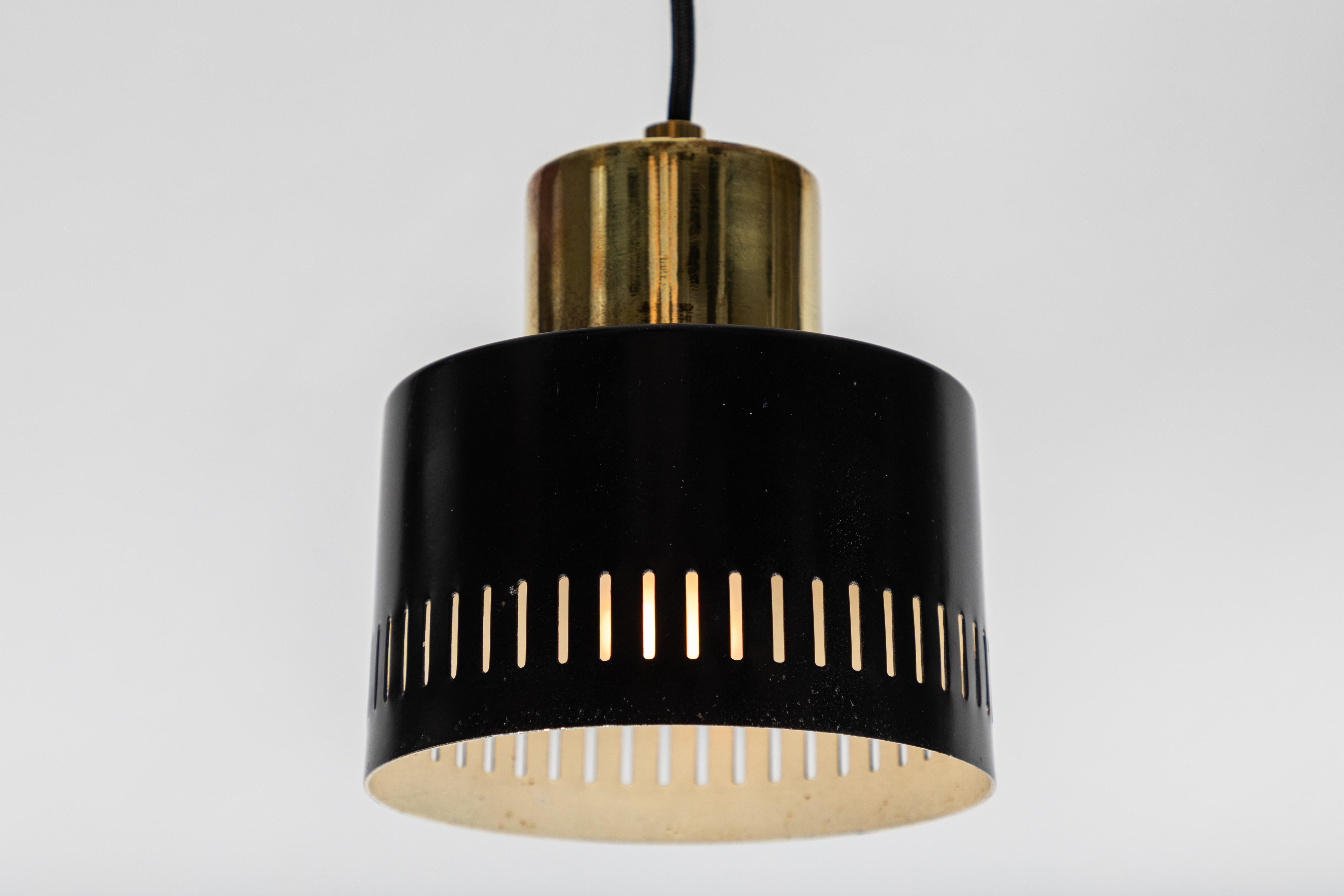 1950s Italian pendant in black and brass attributed to Stilnovo. A quintessentially 1950s Italian design executed in black panted metal and polished brass with a custom fabricated architectural ceiling canopy for mounting over a standard American