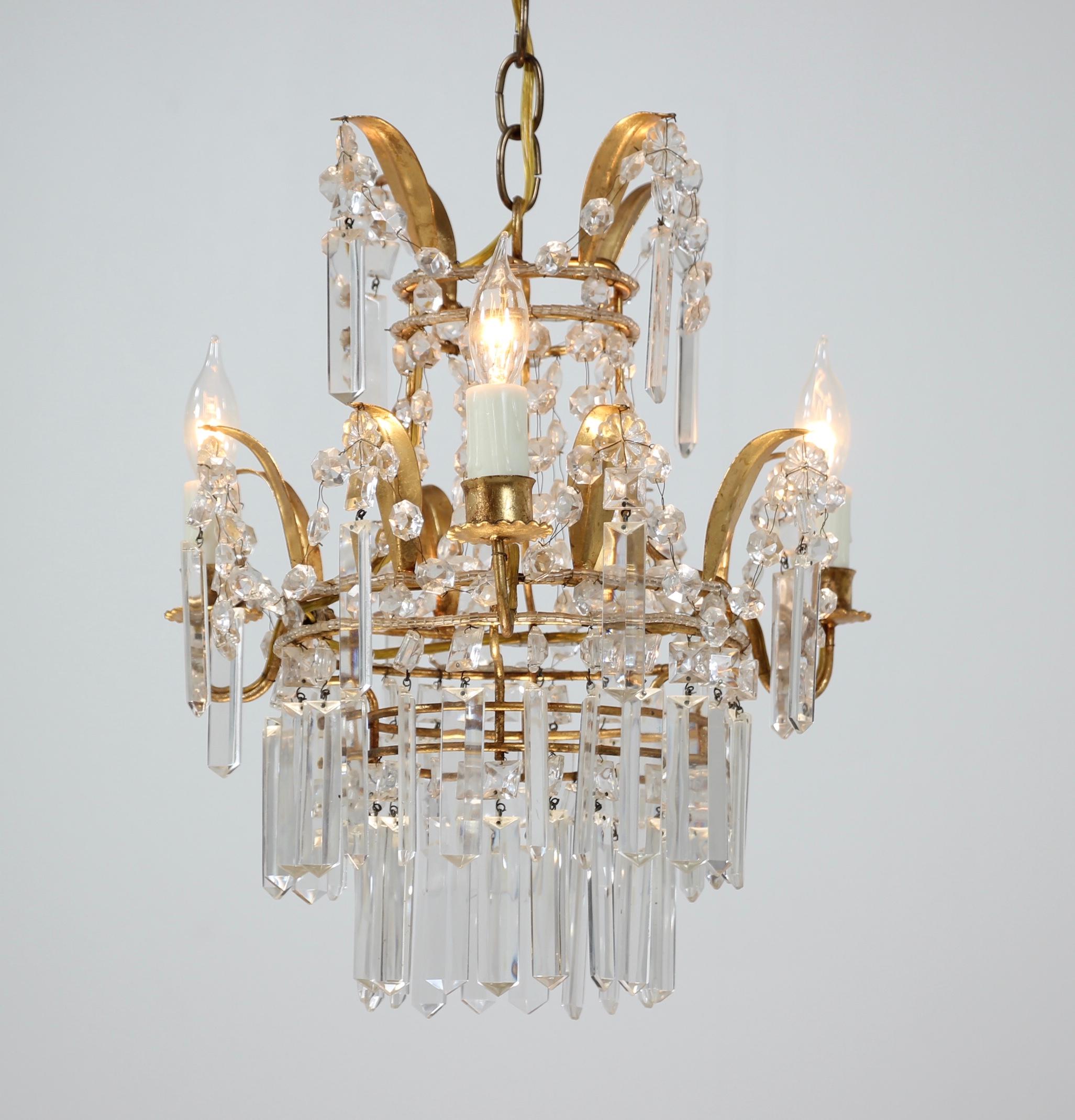 Sparkling, 1950s Italian gilt-iron and crystal beaded chandelier. 

The chandelier consists of a delicately shaped gilded iron frame which has been hand beaded and decorated with crystal prisms. The chandelier requires 3 candelabra base bulbs