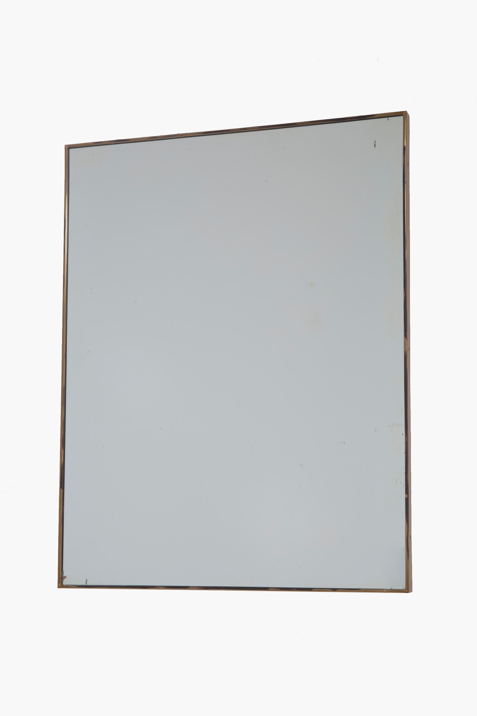 A 1950s Italian brass framed wall mirror. 

Useful size and good rectangular proportions.

Overall very good condition. The gilt finish is rubbed back to antique brass in places. Small areas of foxing to the mirror plate commensurate with age.
