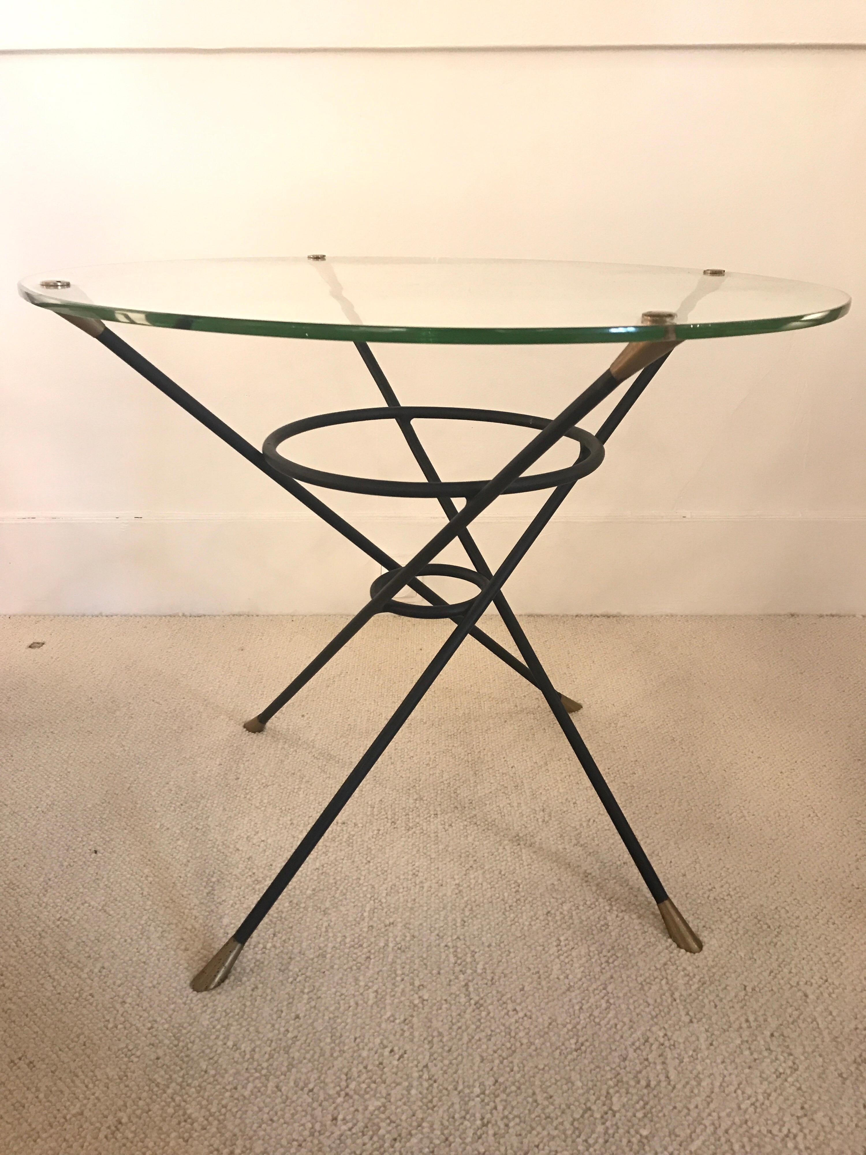 1950s Italian Round table on Glass and iron feet with brass details
Good vintage condition