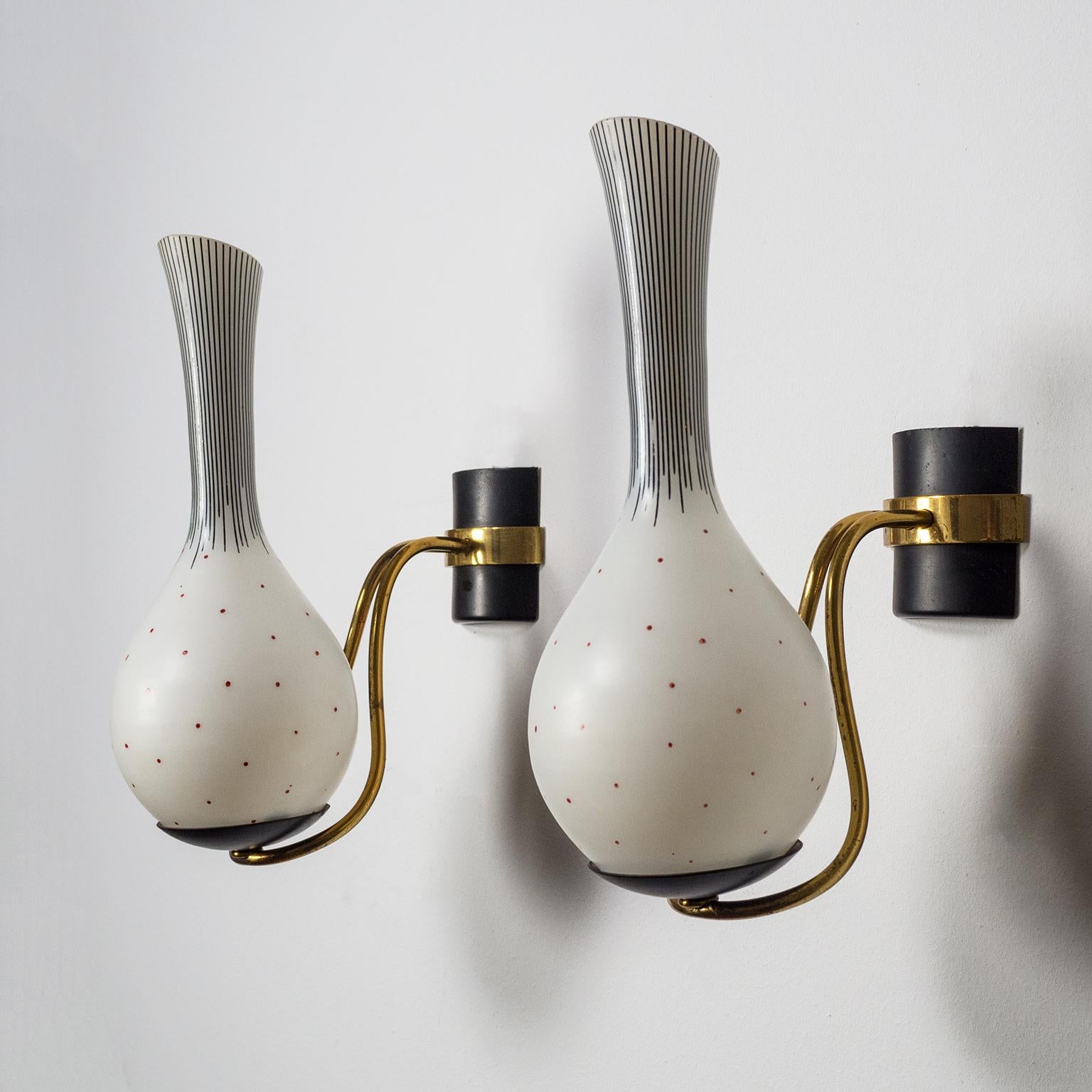 Lovely pair of 1950s Italian brass sconces with very unique hand painted glass diffusers, fine black lines of varying lengths on the long 'neck' and irregular red dots around the body. In combination with the curved brass stems these wall lights
