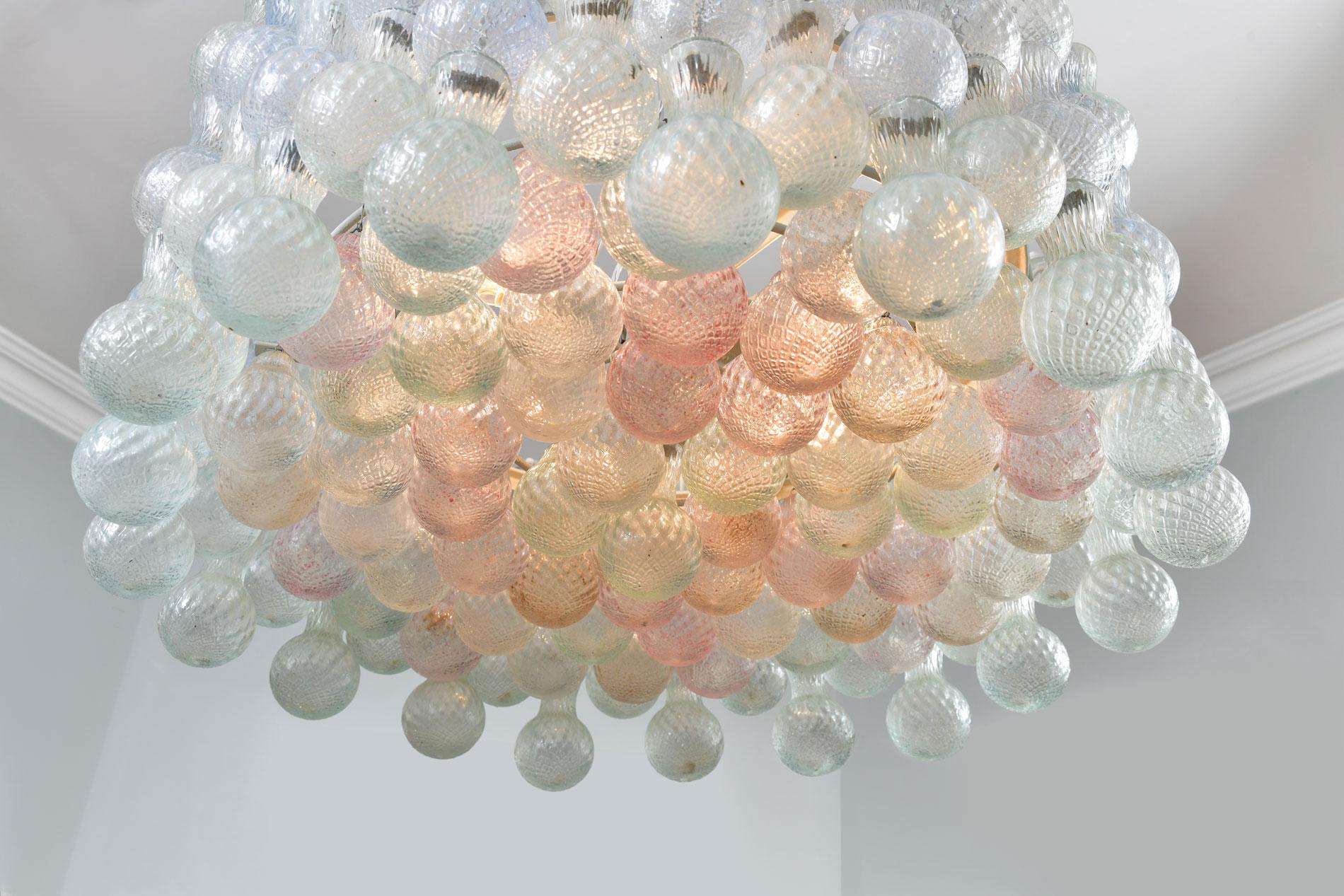 Large and magical midcentury chandelier by the famous Murano glass maker Seguso. The four tiers of textured hand blown glass bubbles are in subtle pastel shades of pink, blue and white.