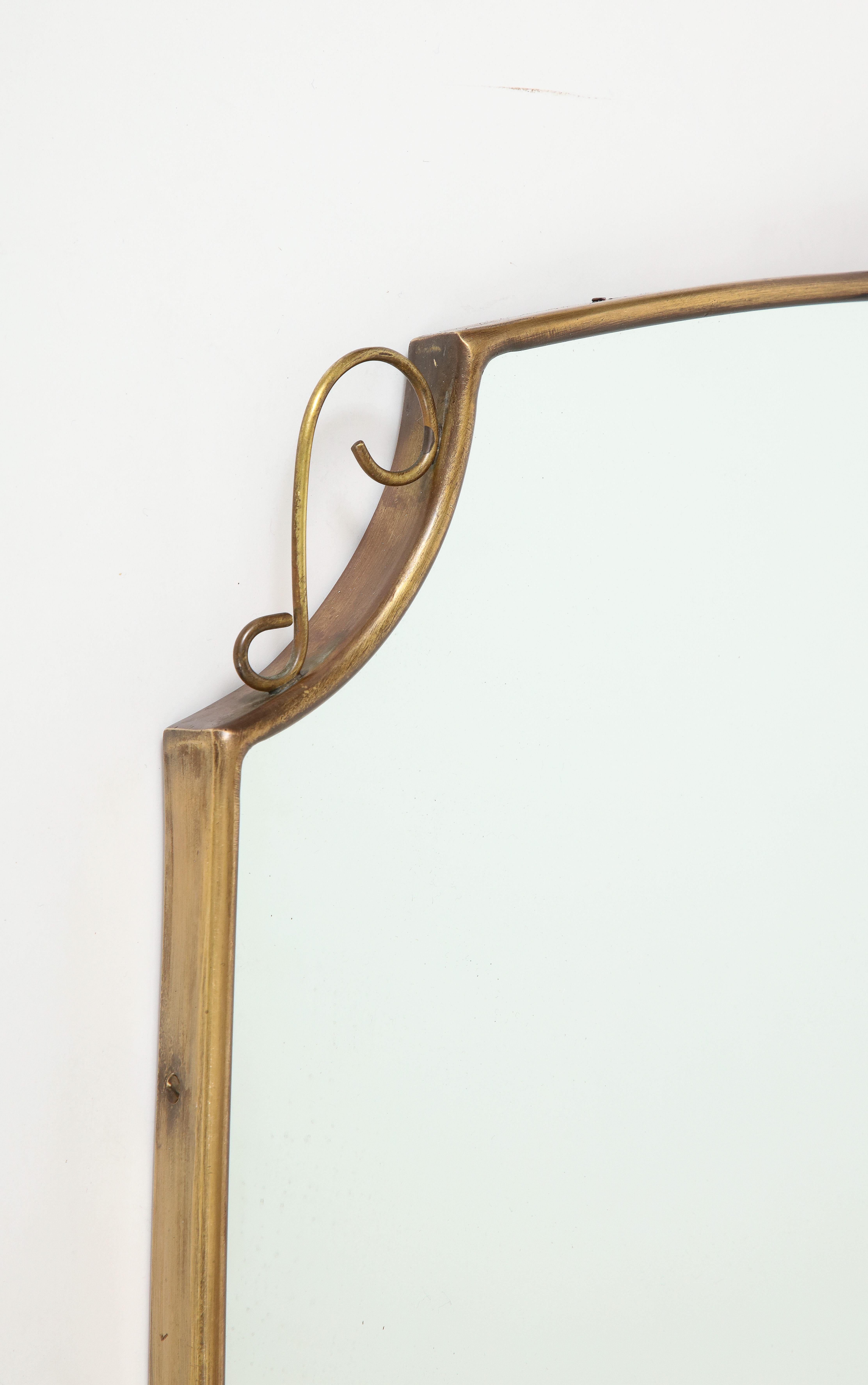 Mid-Century Modern 1950s Italian Shield Shaped Brass Mirror with Scrolls For Sale