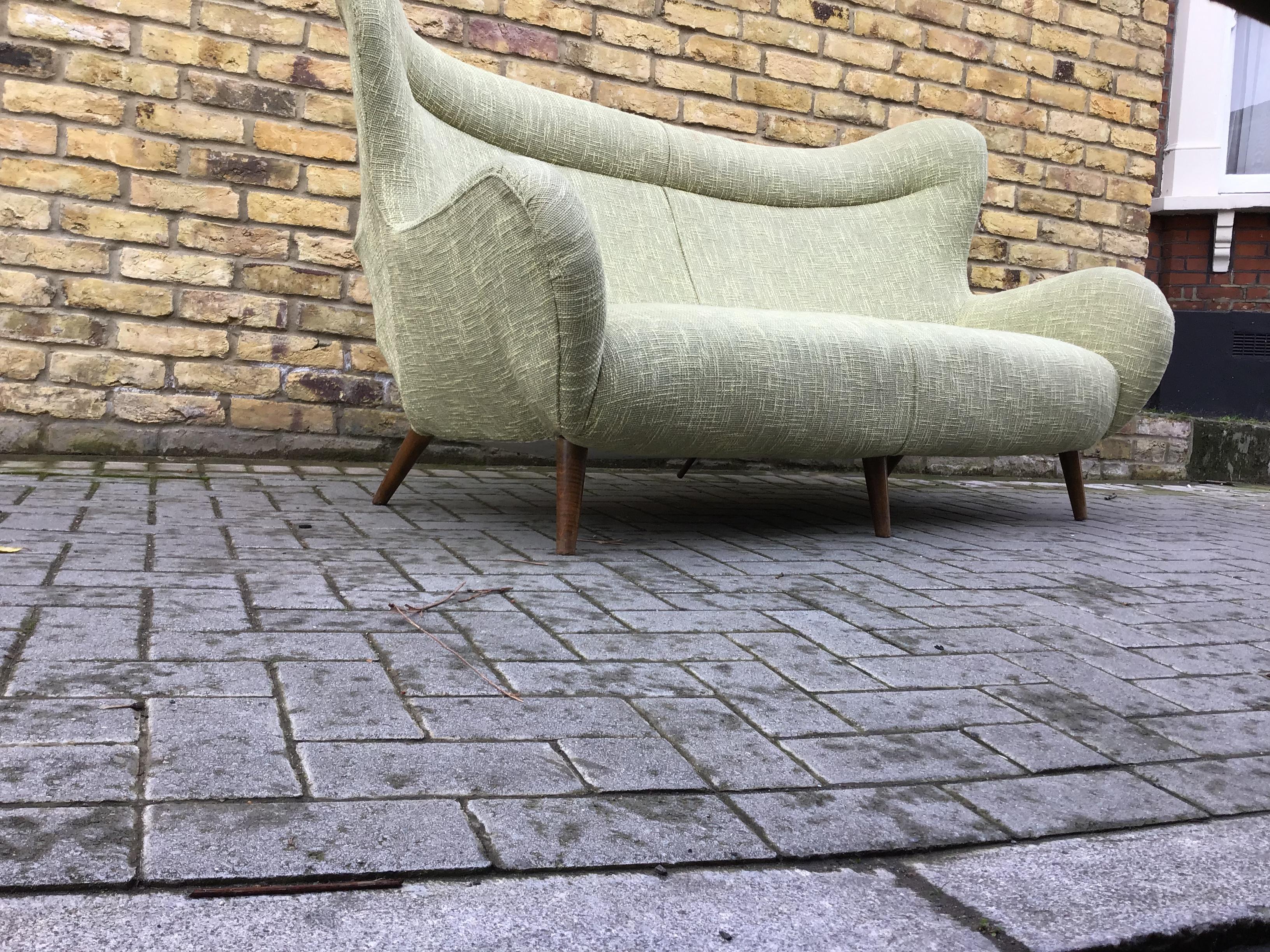 High back comfortable sofa in a vibrant fabric with metal frame
and wooden tapered legs. Nice organic shape circa 1950s Italian.
 