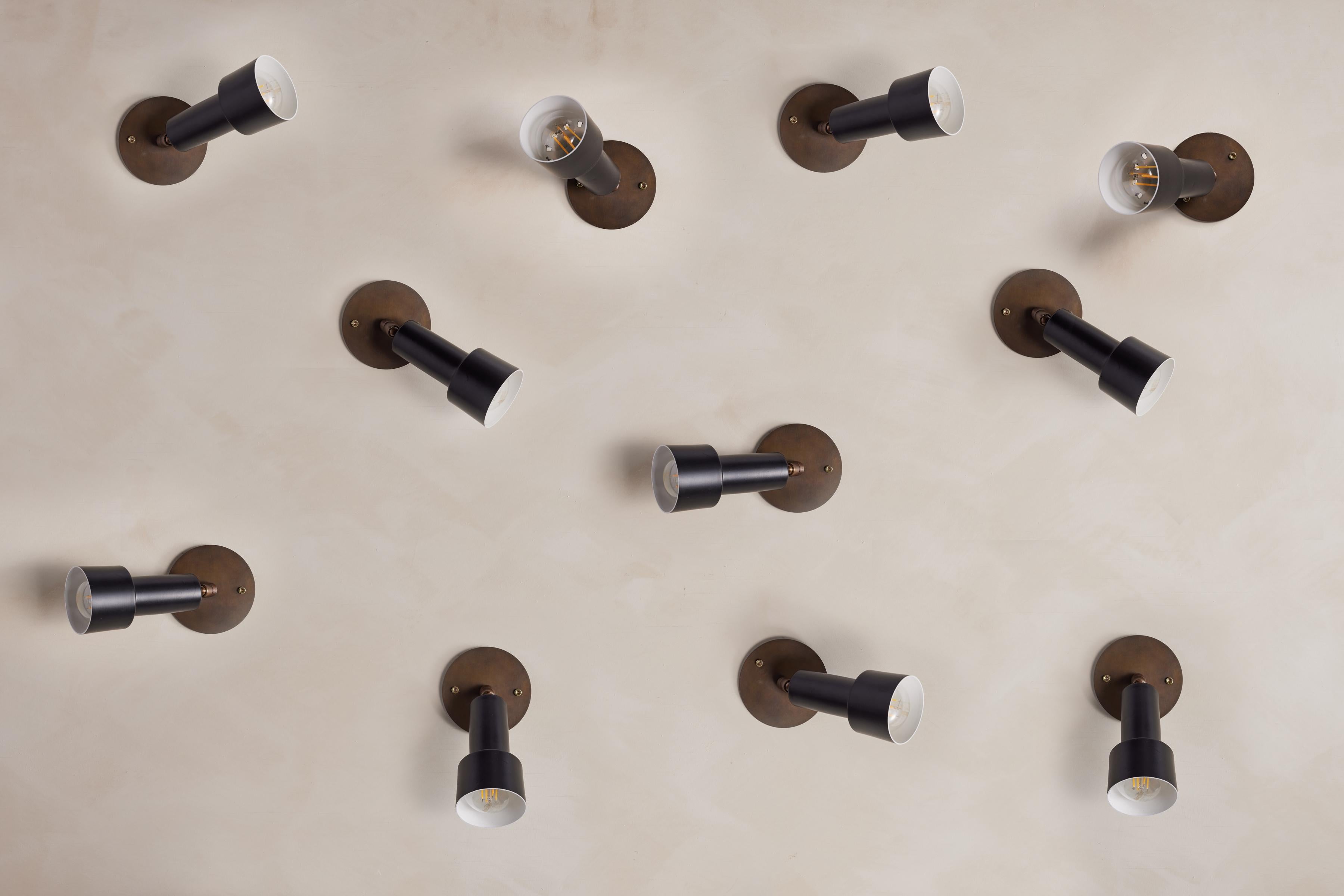 Eleven adjustable spotlights with black industrial shaped shade with brass

Articulates in all directions 

Italy, 1950s. 
