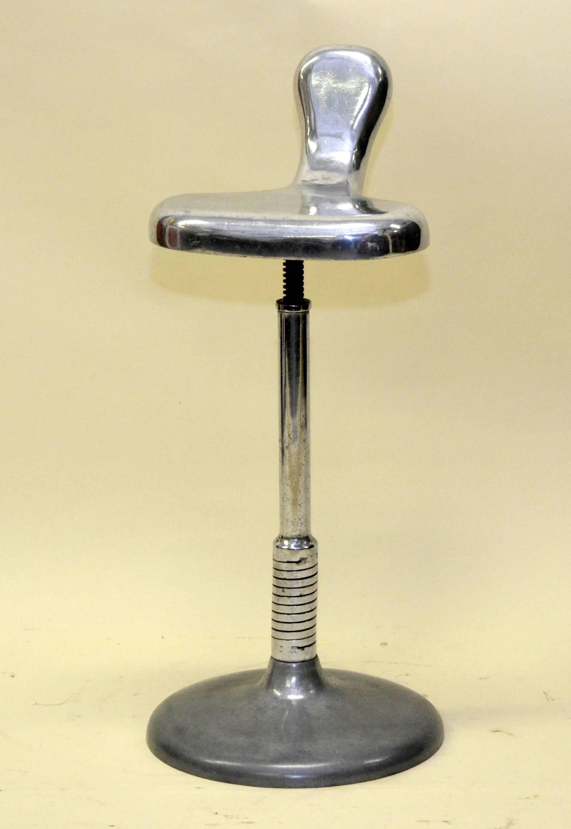 A beautiful 1950s Italian vintage Industrial steel dentists stool. With a unusual polished cast iron base, sprung upright mechanism. The stool offered precision support at various angles while the dentist was at work.