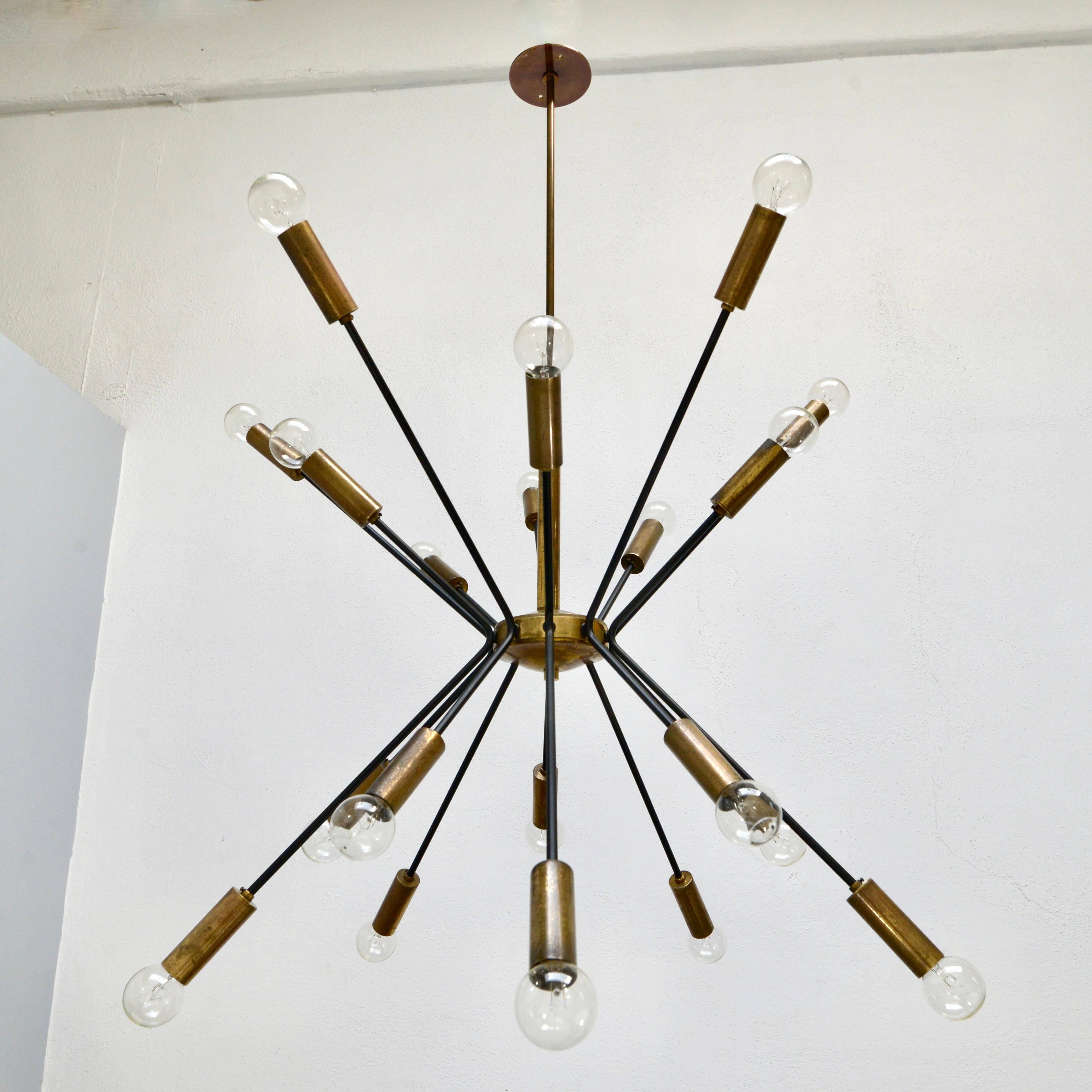 A stunning 1950s chandelier from Italy attributed to Stilnovo, with original brass and painted aluminum finish.  Partially restored and rewired with 20 E12 candelabra based sockets. for use in the US. Light bulbs included with order.