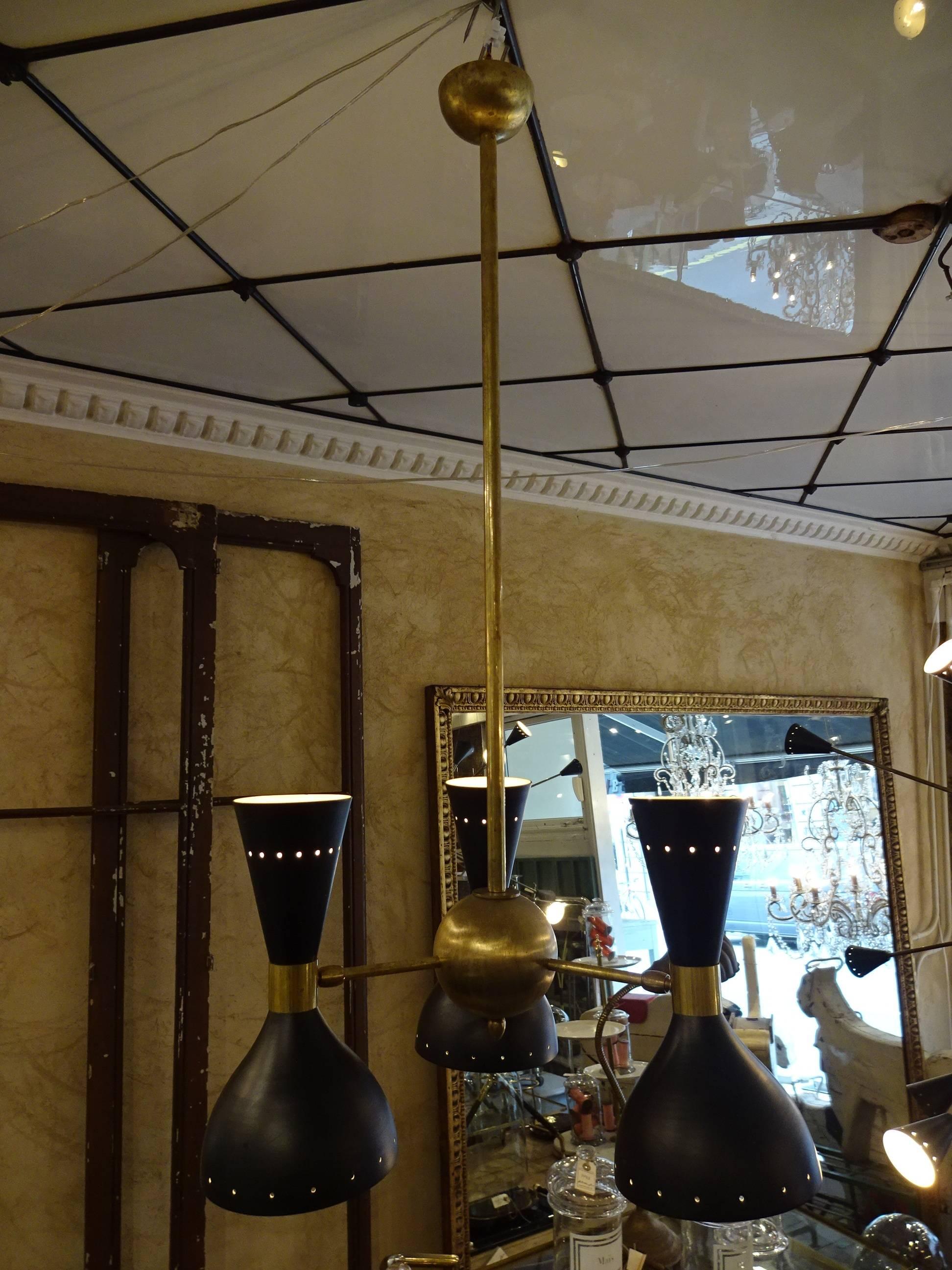Classic and handsome brass and black ceiling lamp, attributed to Stilnovo, circa 1955. There are three movable lampshades with light sources at both ends.

 