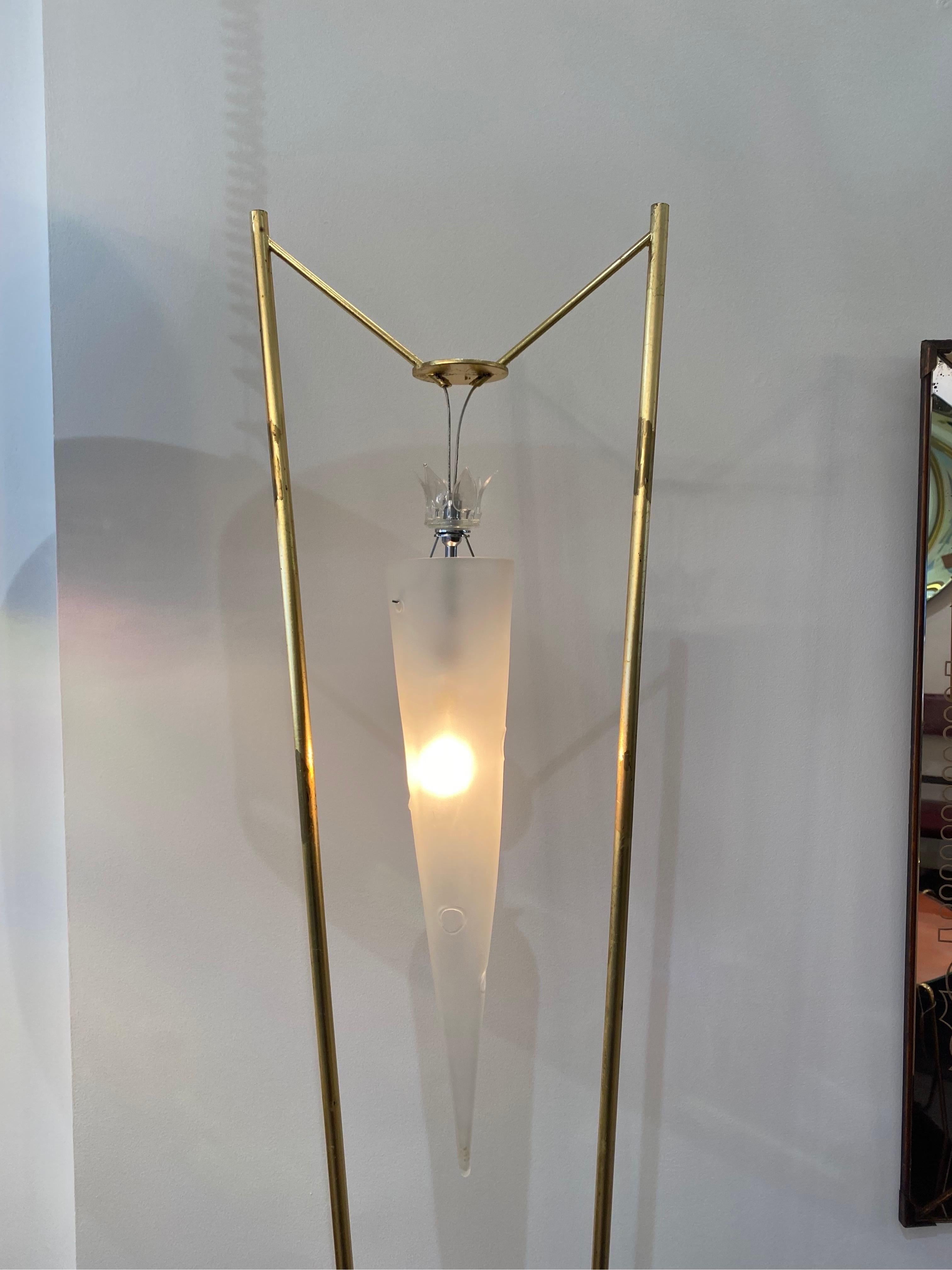 Murano masters Italian production c.1950s floor lamp standing on a very thick murano glass base, with golden metal structure. The hand blown frosted glass cone shaped diffuser is suspended in the center. 
Lit: L'avventura del vetro dal Rinascimento