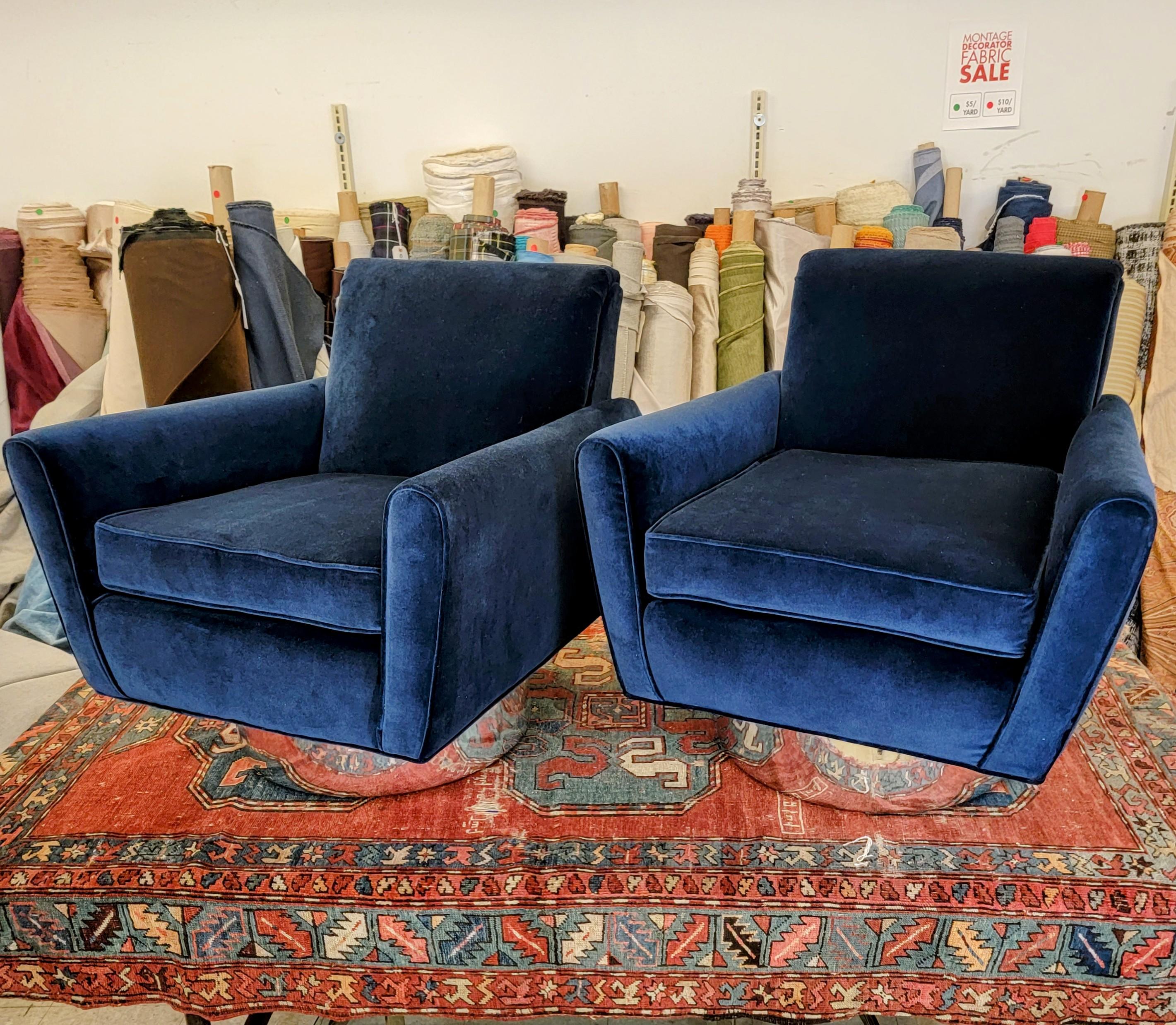 This unique pair of Italian swivel tub chairs, in the style of Marco Zauso, has been newly reupholstered in a plush dark blue velvet with mirror chrome vinyl over the bases. The fin-like ascending lines of the arm rests are hugely inspired by the