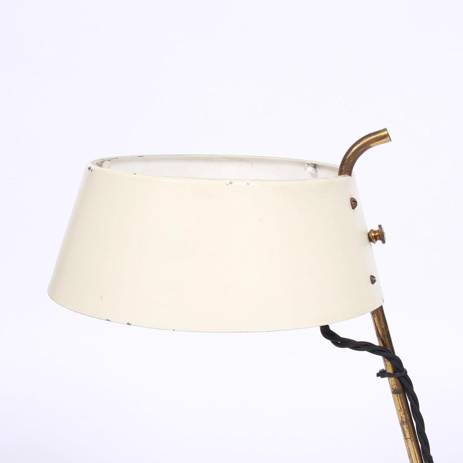 Italian, circa 1950

A small table lamp with a cream metal shade and chic 