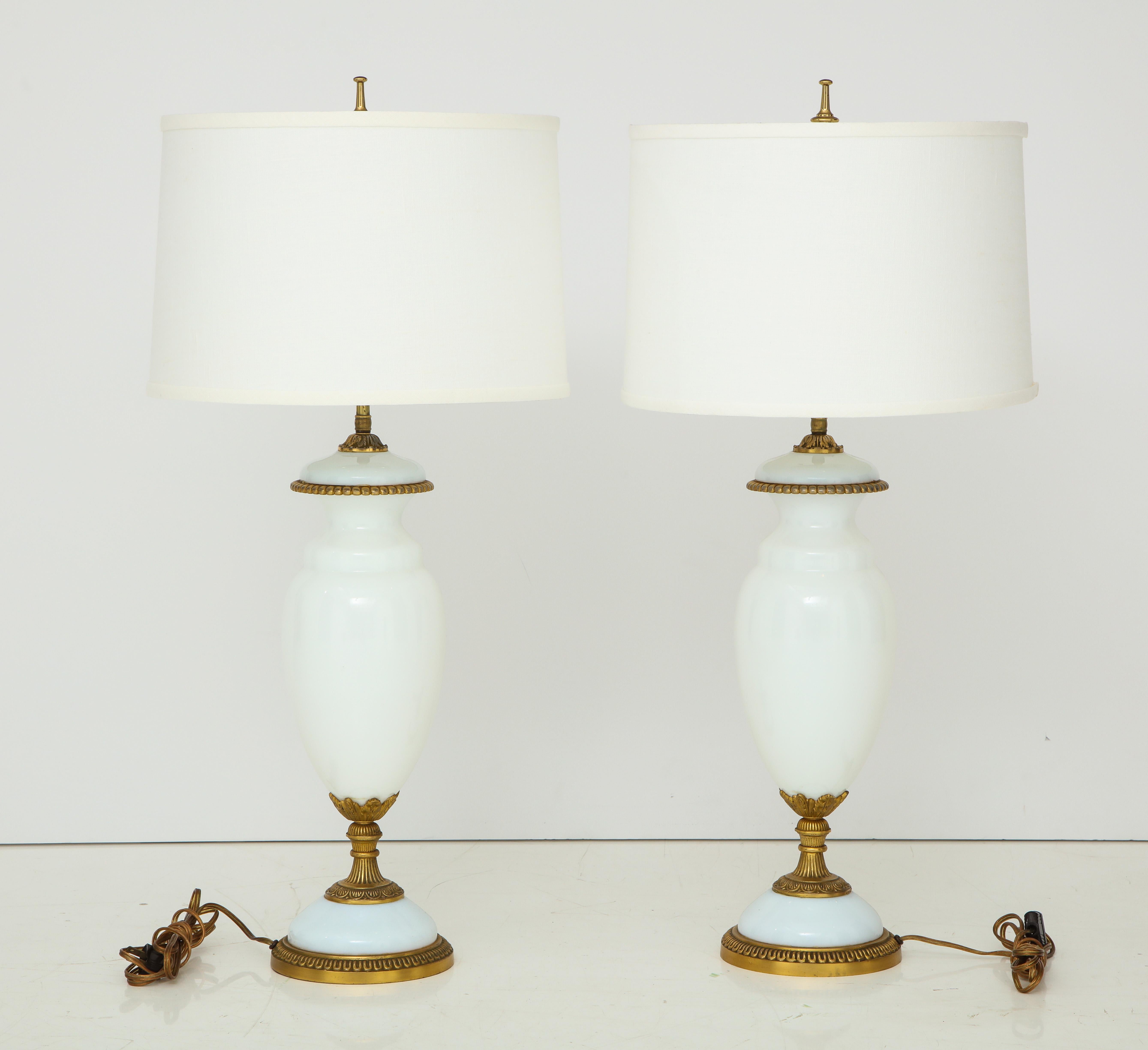 Stunning pair of 1950's Hollywood Regency style milk glass and brass Italian table lamps, in vintage original condition with minor wear and patina due to age and use.