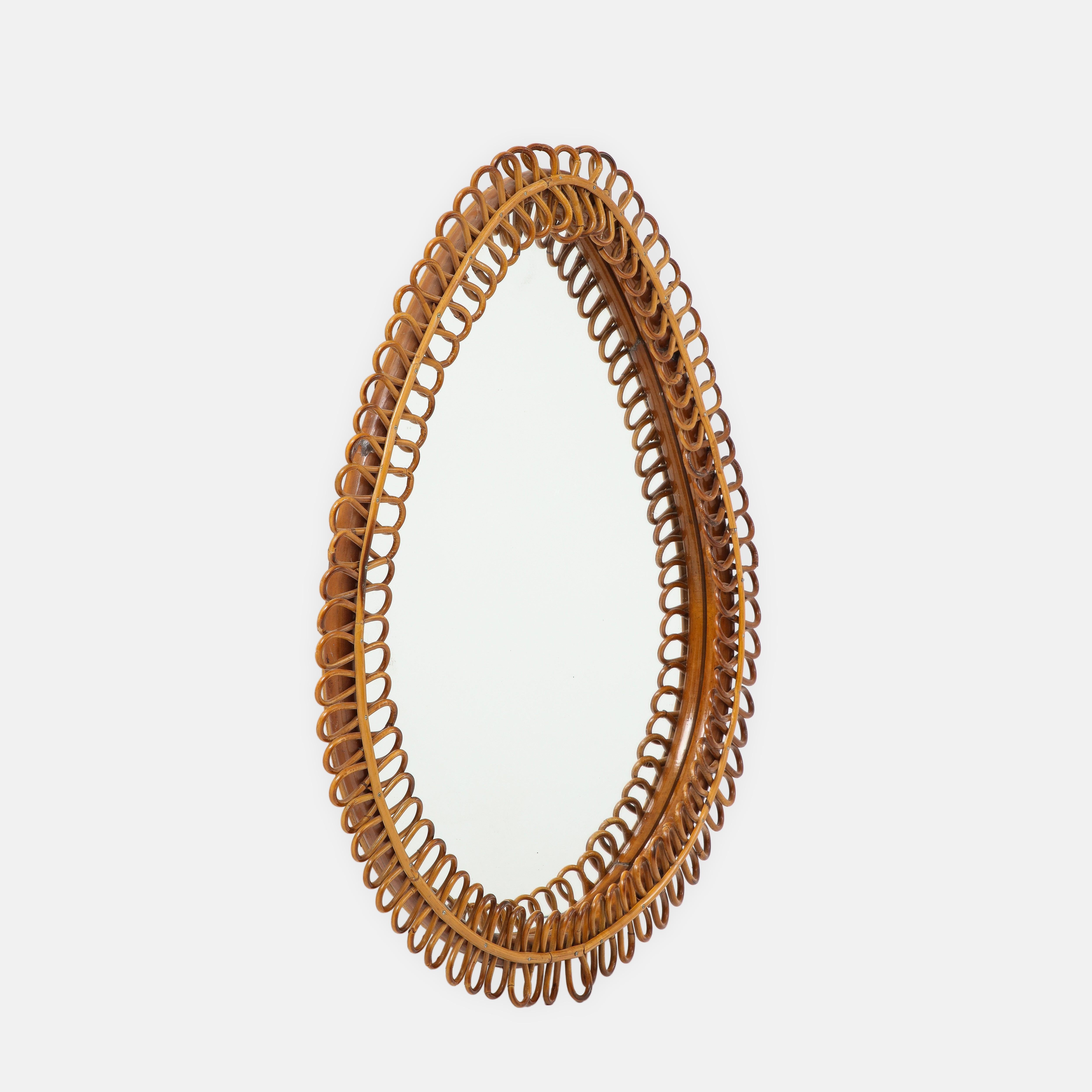 Italian 1950s mirror with hand-woven rattan frame in elegant teardrop shape.
