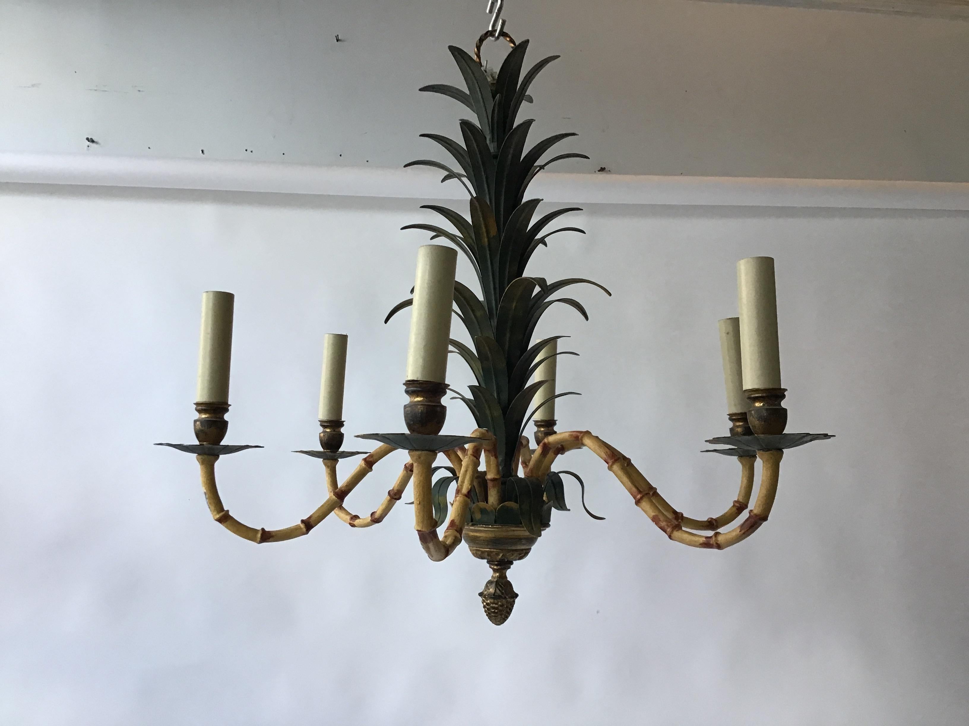 1950s Italian tole palm tree chandelier, from a palm beach estate. There are also matching sconces to accompany this item.