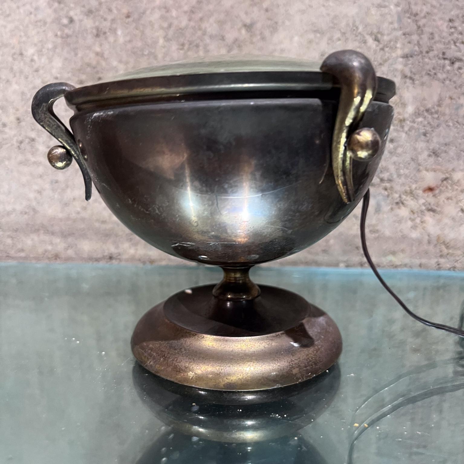 from AMBIANIC
1950s Sculptural Brass Urn Table Lamp from Italy
attributed Fontana Arte and Gio Ponti
unmarked.
glass magnifying top
4.25 h x 6 diameter
Original Unrestored Preowned Vintage Condition. Rewired.
Please expect vintage wear with patina