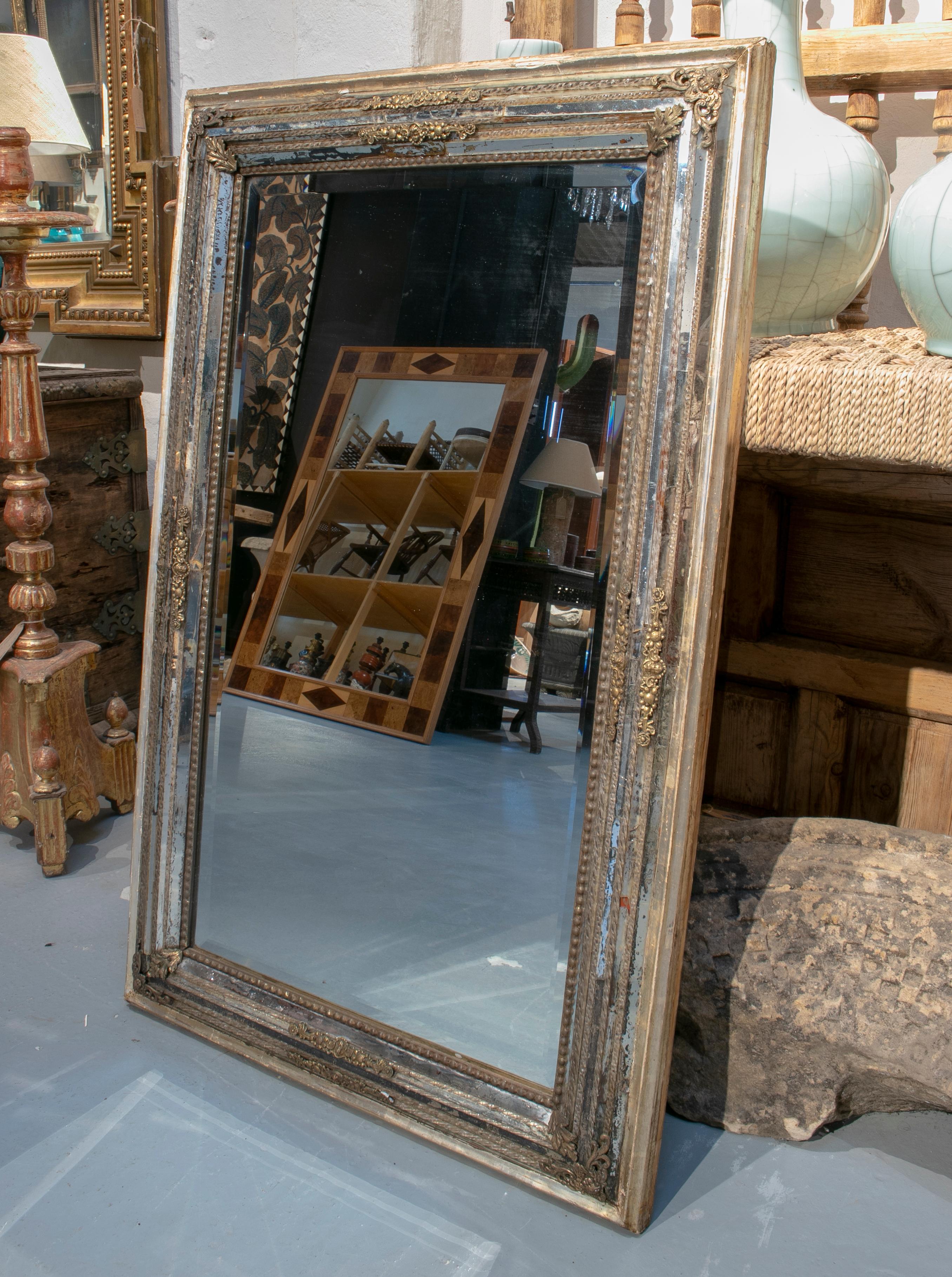 1950s Italian Venetian mirror with glass studded frame and bronze decorations.