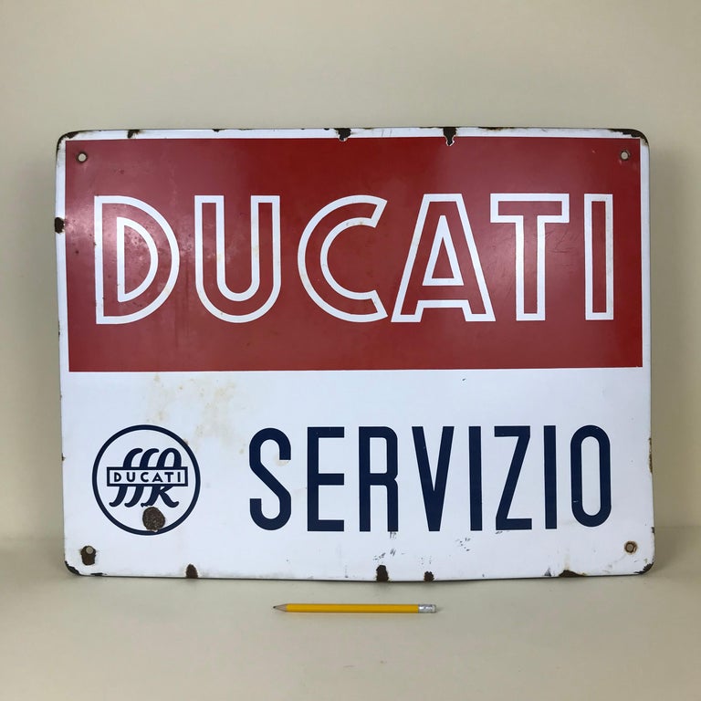 Vintage rectangular metal enamel Ducati Bikes sign produced for advertising purposes by Smalti Firenze in Italy in the 1950s.
Red and white Ducati Logo and world 