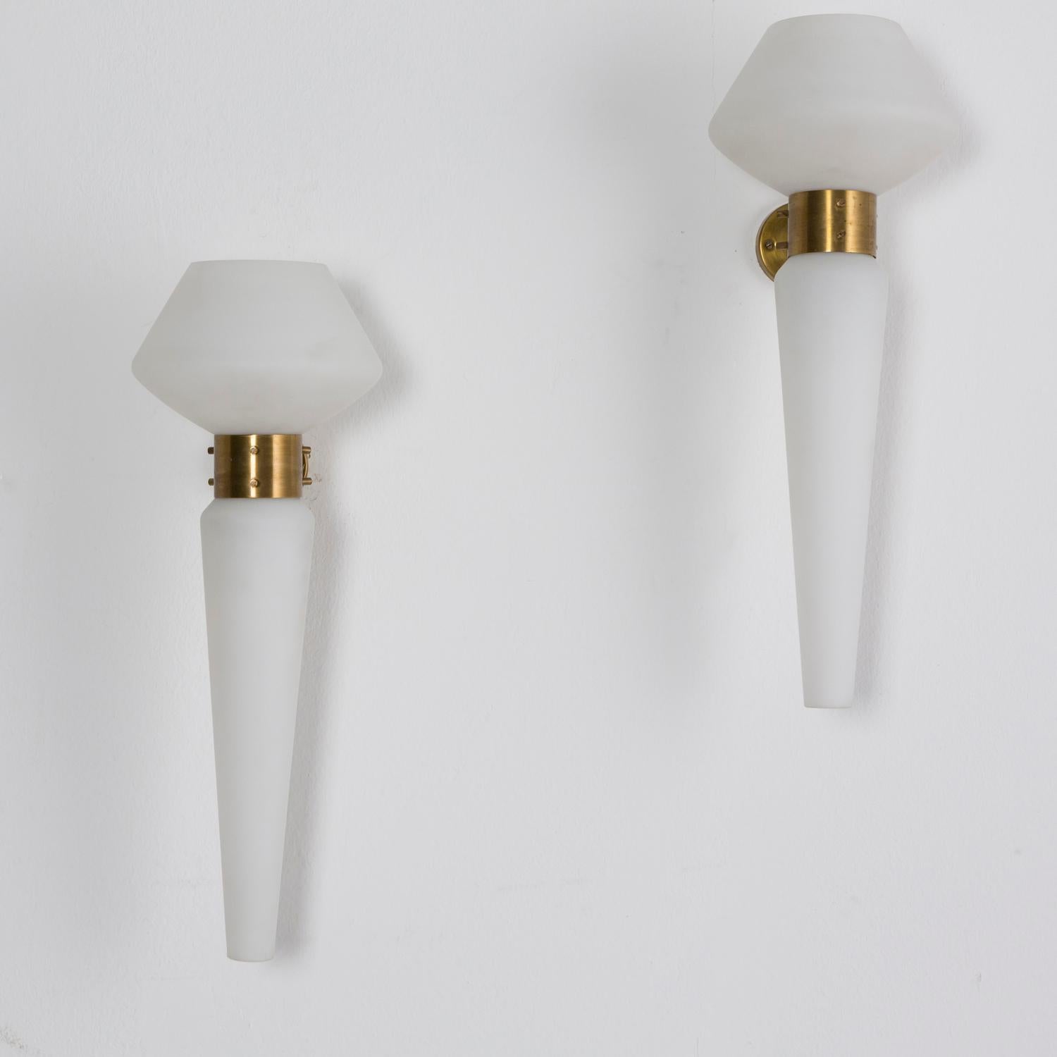 Pair of tall wall lamps manufactured in Italy in the 1950s in the manner of Stilnovo, made from two white opaline glass diffusers that can be inverted. Brass support.