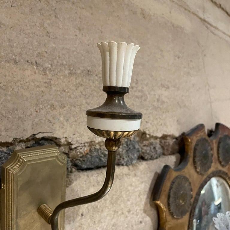 
Old World Sculptural Italian Wall Sconce Pair 
Style of Gio Ponti 1950s
Two arms each sconce.
Elegant wall plate.
No label, attributed to style of Gio Ponti Italy
13 d x 10.75 tall x 3.5 w
Original unrestored preowned vintage condition. 
See images