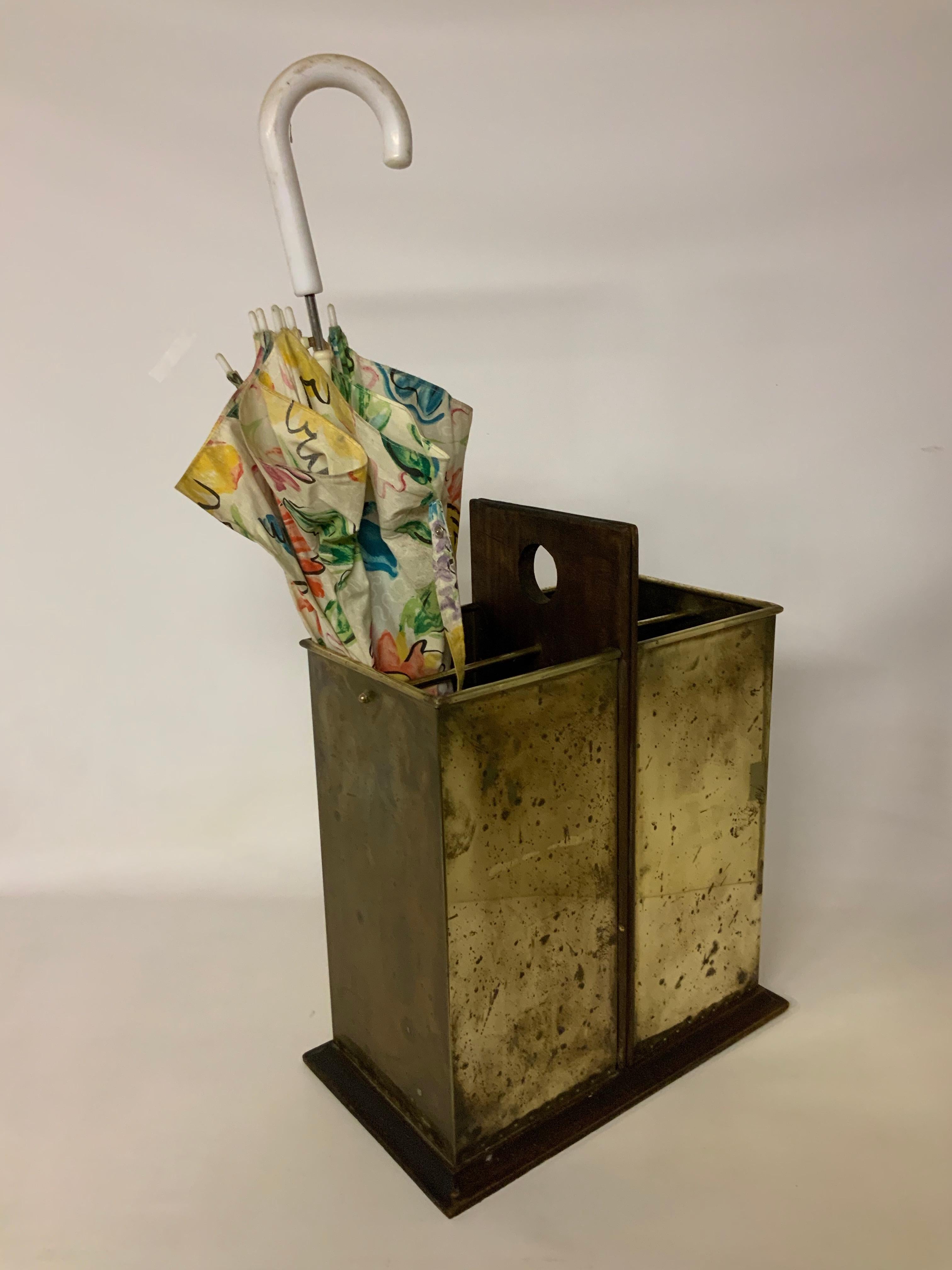 Stylish Italian made walnut and brass umbrella stand in the manner of Sarreid Ltd. circa 1950. Featuring solid walnut construction with brass tacked bottom edge and a rolled top edge. Each compartment has a brass rod partition. Stamp signed, Made in