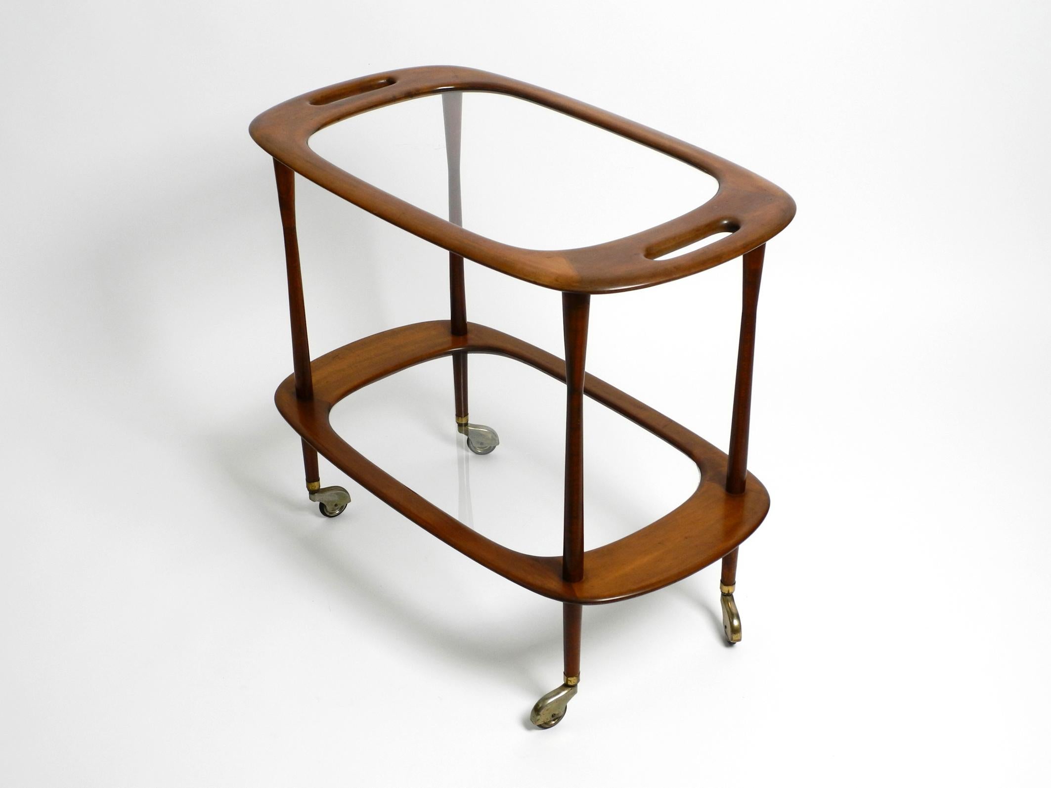 Beautiful Mid Century Modern bar or serving trolley made from walnut and glass.
Designed by the Italian architect and designer Cesare Lacca.
Manufactured by Cassina in the 50's. Great minimalist design. Made in Italy.
This bar cart has no label. But