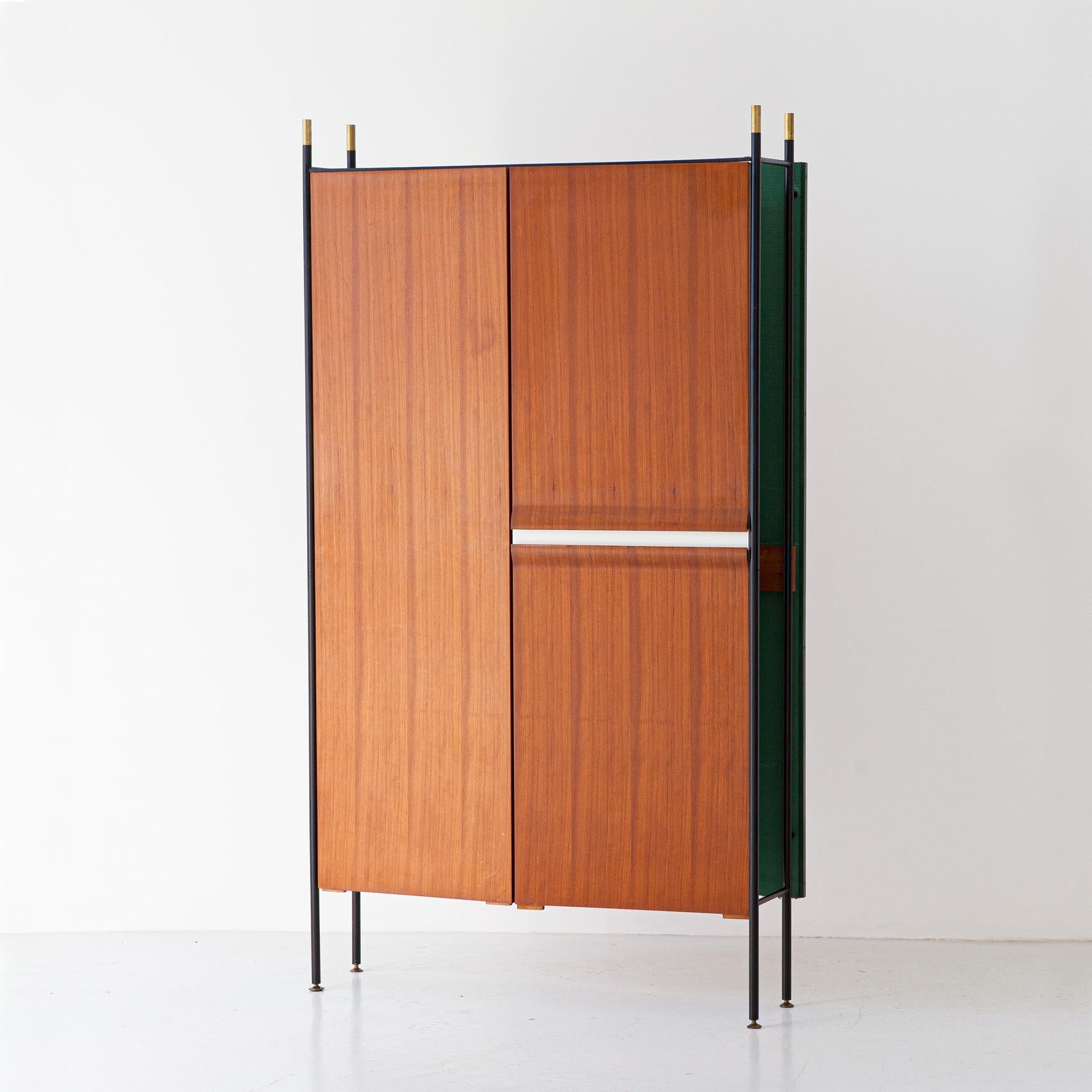 Italian Wardrobe, teak, green fabric, iron and brass, 1950s

This incredible cabinet of mid-century modern Italian design boasts ultra modern lines along with technical details of high Italian carpentry.

It has four brass and black enameled