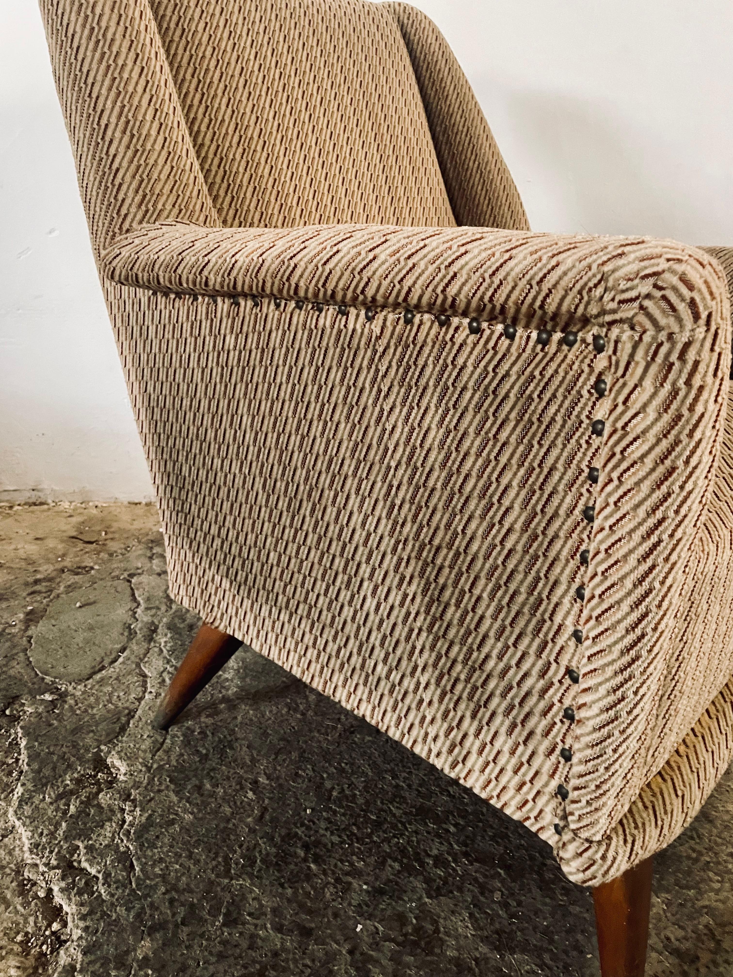 Exceptional pair of 1950s Italian armchairs embodying the elegant simplicity of mid-century modern design, heavily influenced by Gio Ponti's revolutionary aesthetic that defined an era of Italian furniture craftsmanship.

These architectural wing