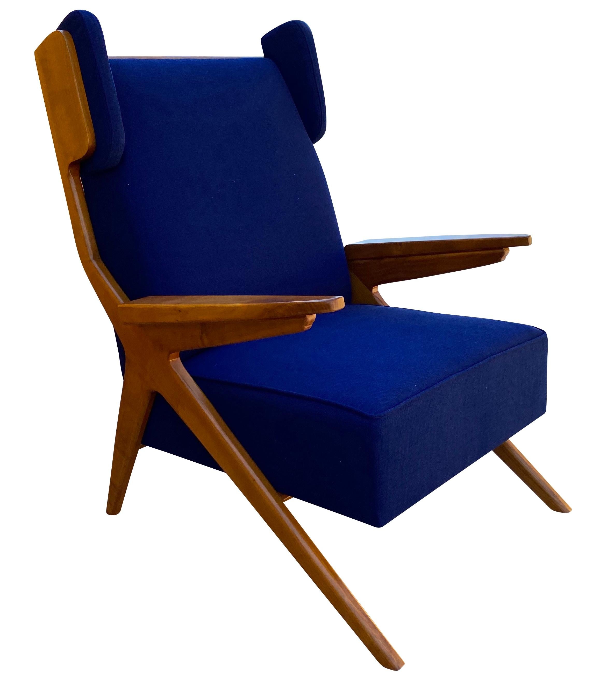 A pair of elegantly proportioned Italian cherrywood wingback armchairs upholstered in electric blue fabric.

 