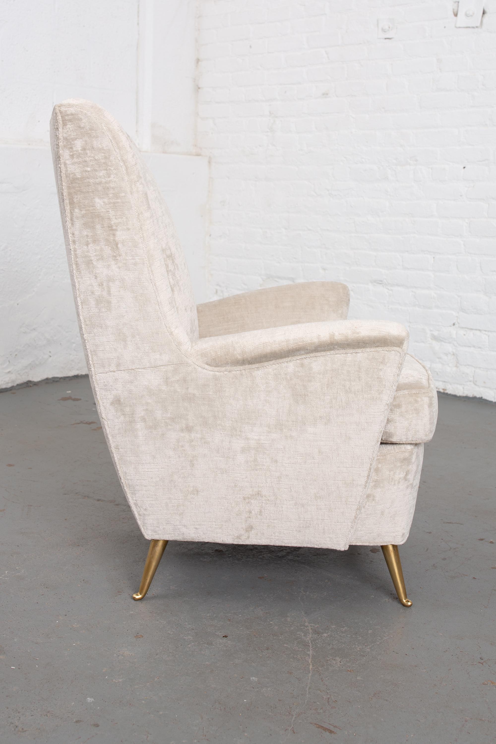 Newly upholstered Italian Moderne wingback chair with brass legs and curved back. Very comfortable.
Measures: Seat depth 18.5