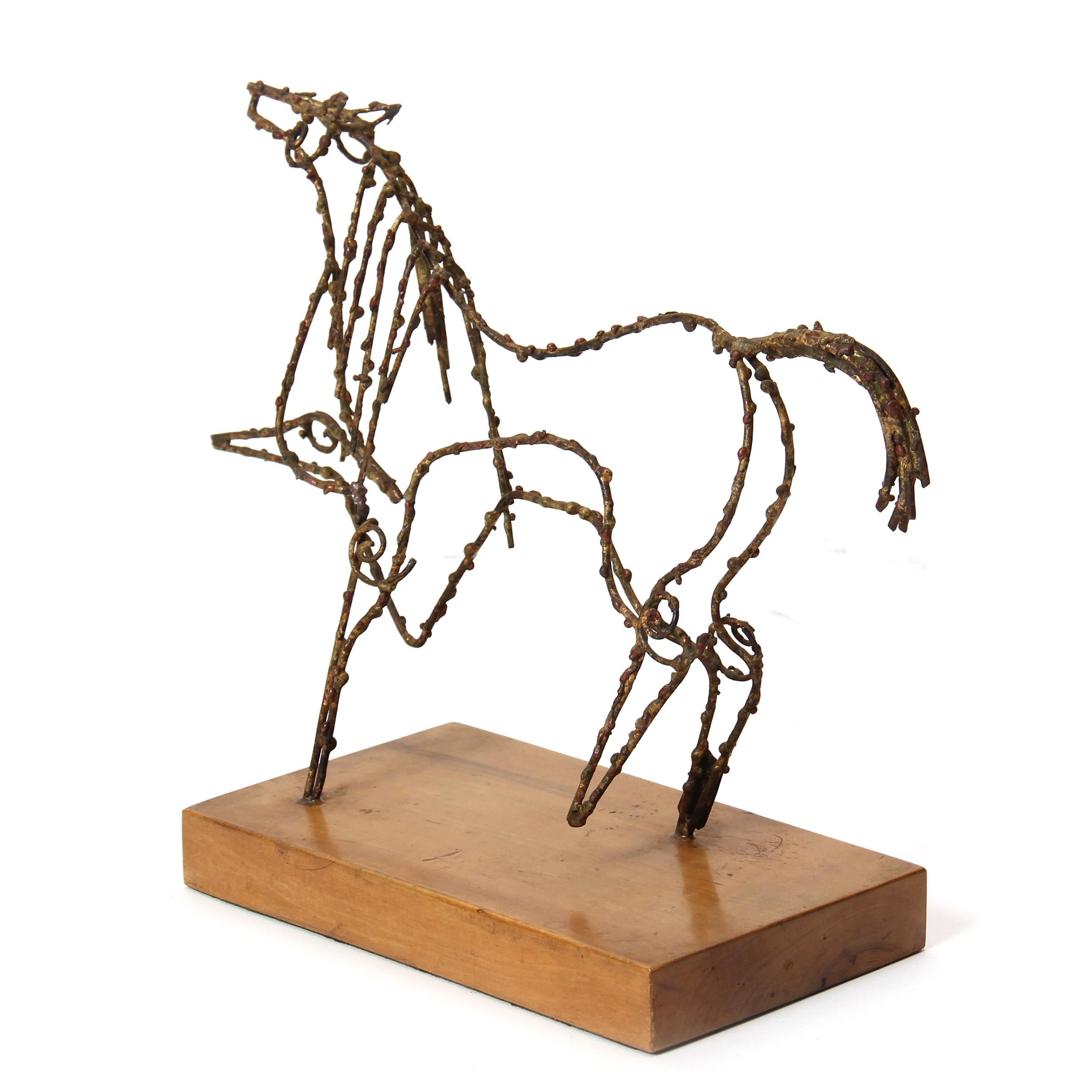 A bronze wire sculpture of a prancing horse on a wooden base.